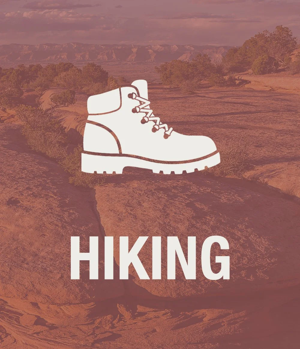 Illustration of a hiking boot overlaid on a desert landscape background with the word 'HIKING' written beneath.