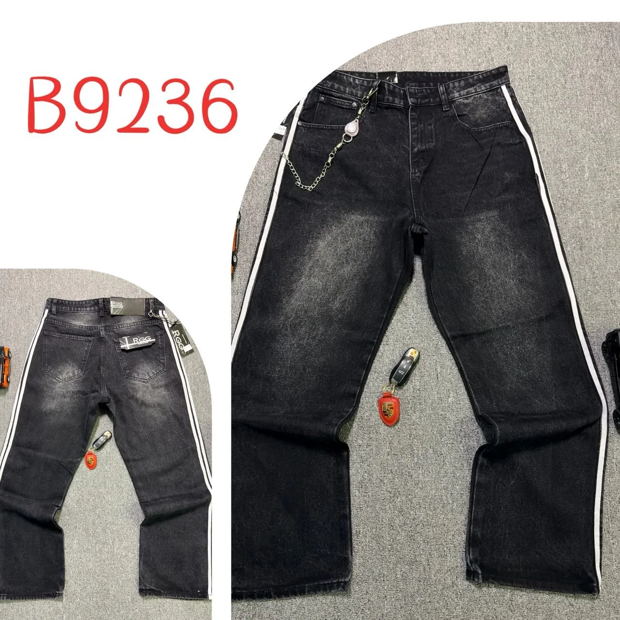Pair of black jeans with white stripe down the sides, displayed on a grey surface. Close-up of the back showing two pockets and brand tags, with a keychain attached to the belt loop. The larger image shows the front of the jeans with a chain accessor