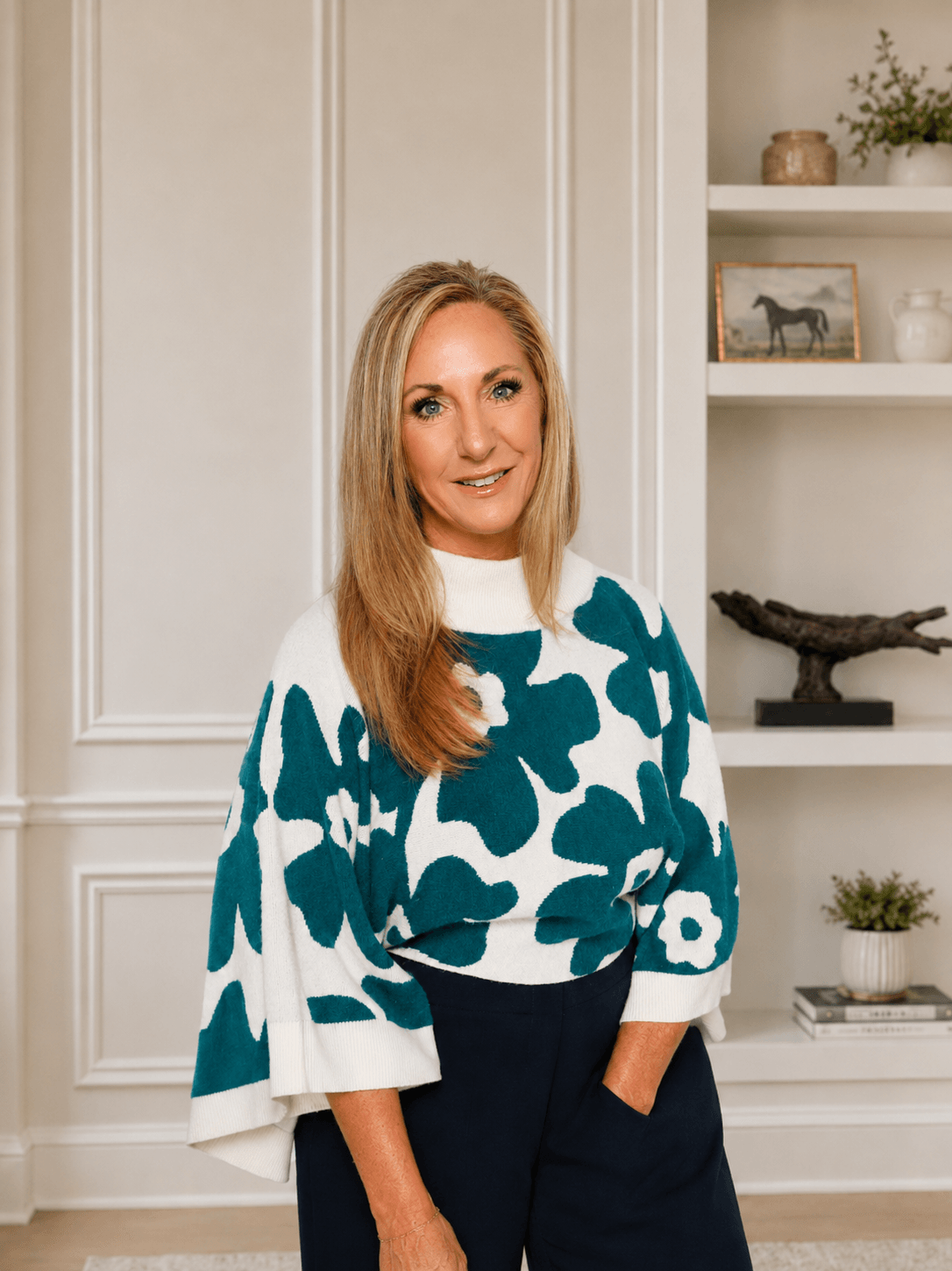 CoHost Works founder standing in a styled home interior, representing the company’s personal, strategic approach to vacation rental management.
