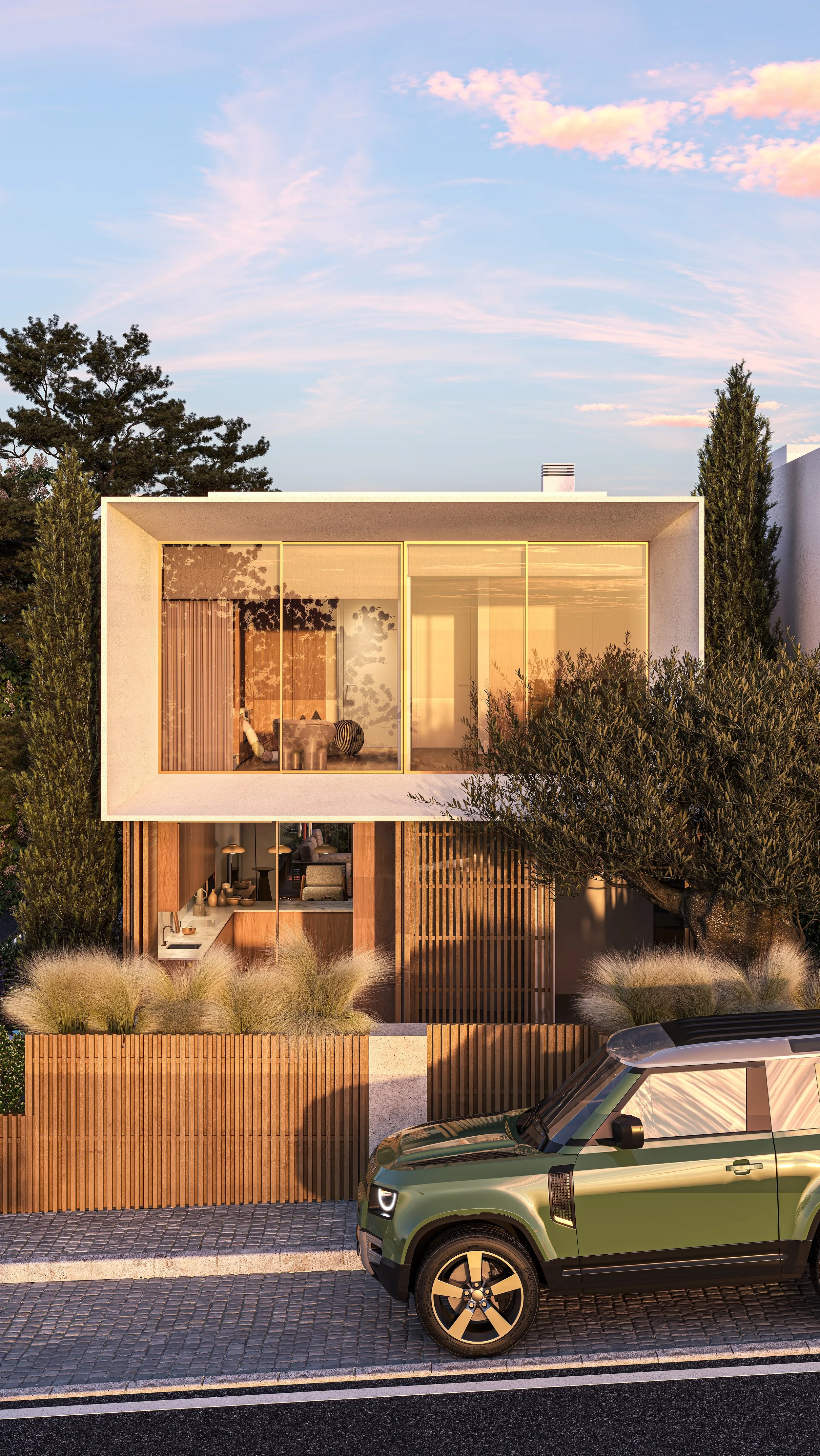 Modern architectural house with large glass windows, surrounded by trees and plants, with a car parked on cobblestone street in the foreground.