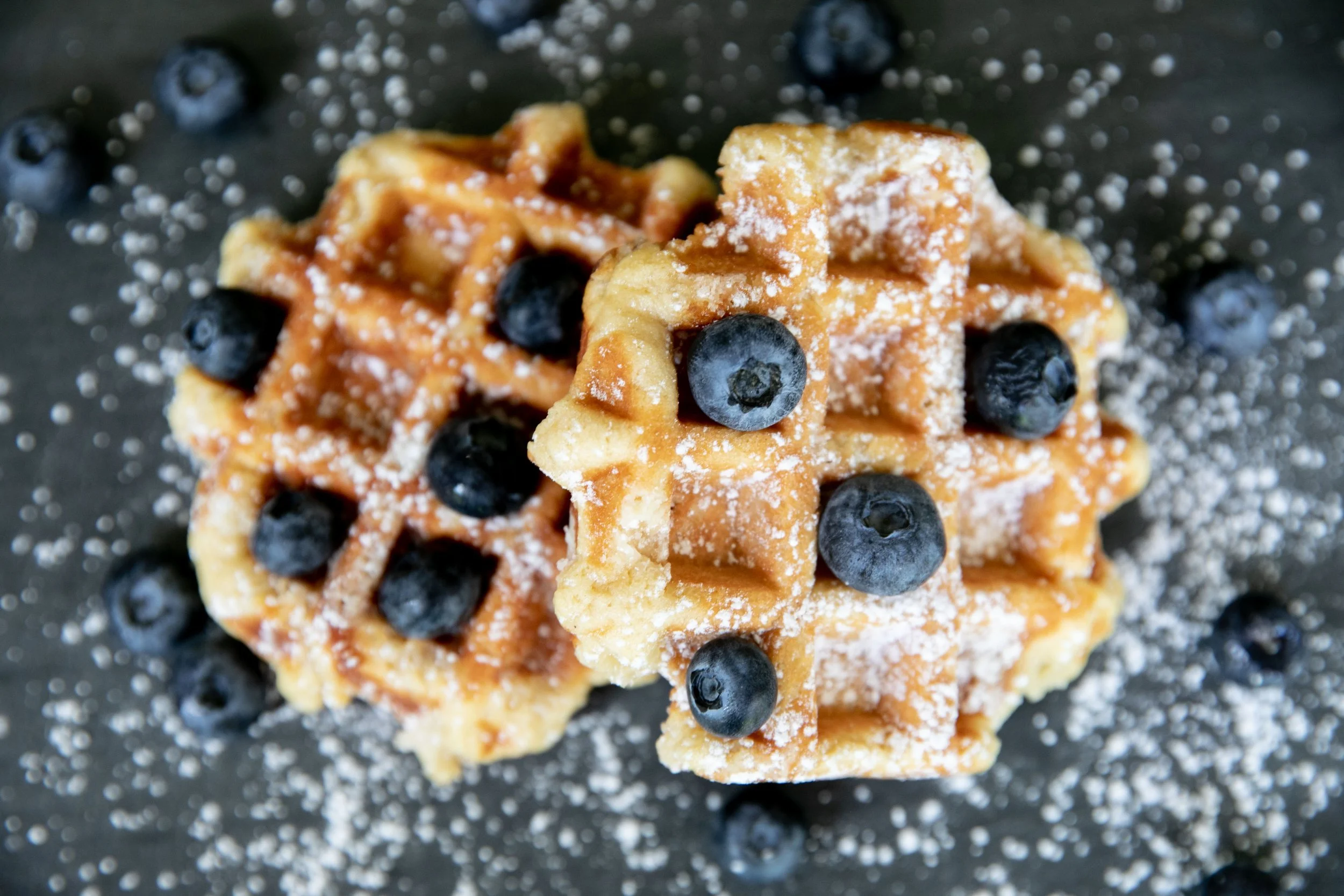 liege waffles topped with powered sugar and blueberries by the Belgian Princess Waffles