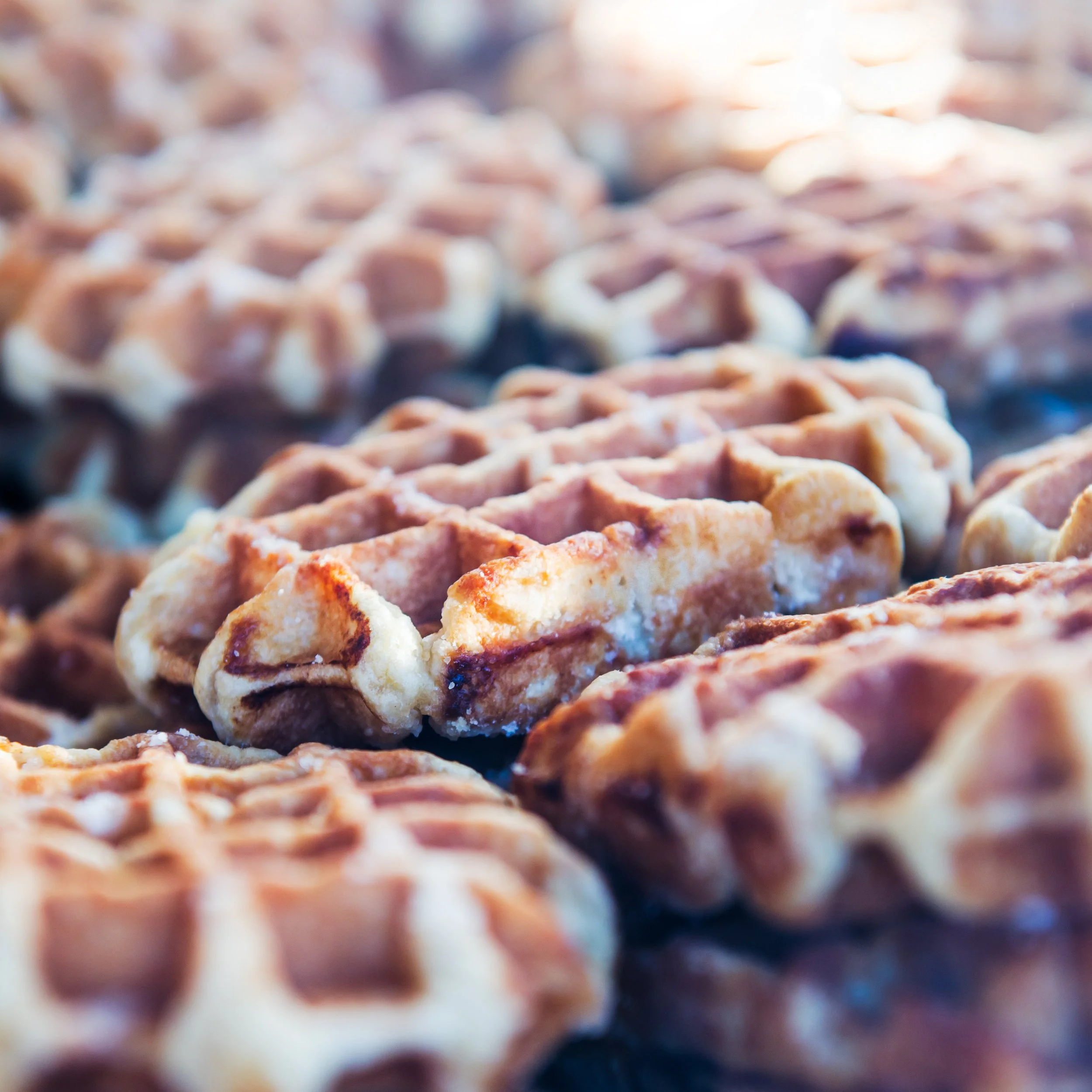 Close-up of freshly baked waffles with golden brown edges.