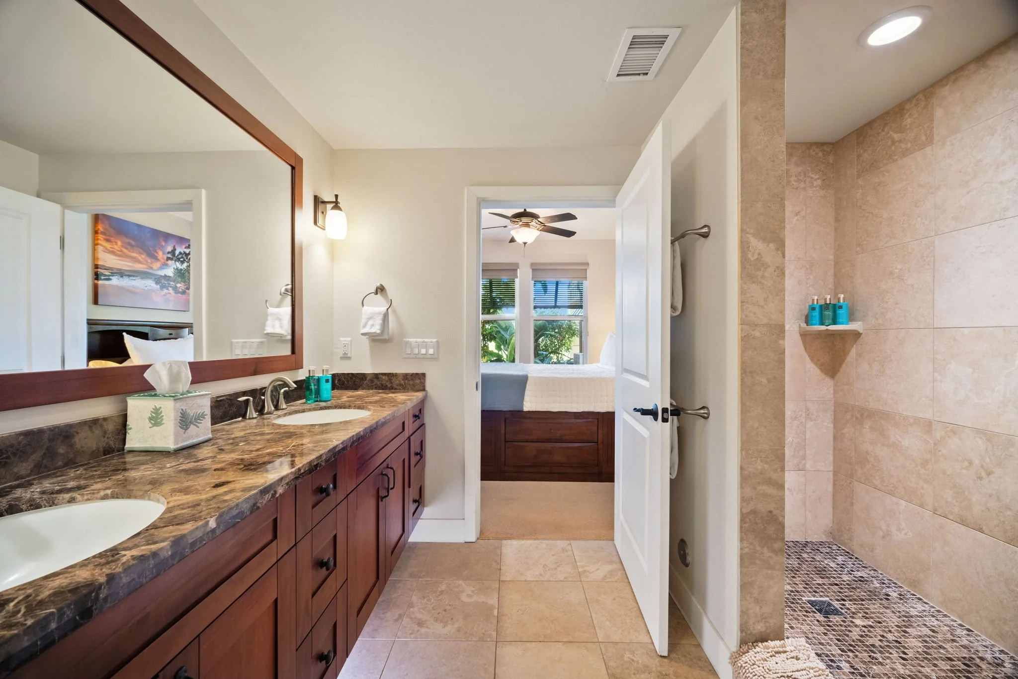 Master bathroom with dual vanity, granite countertops, and wood-framed mirror