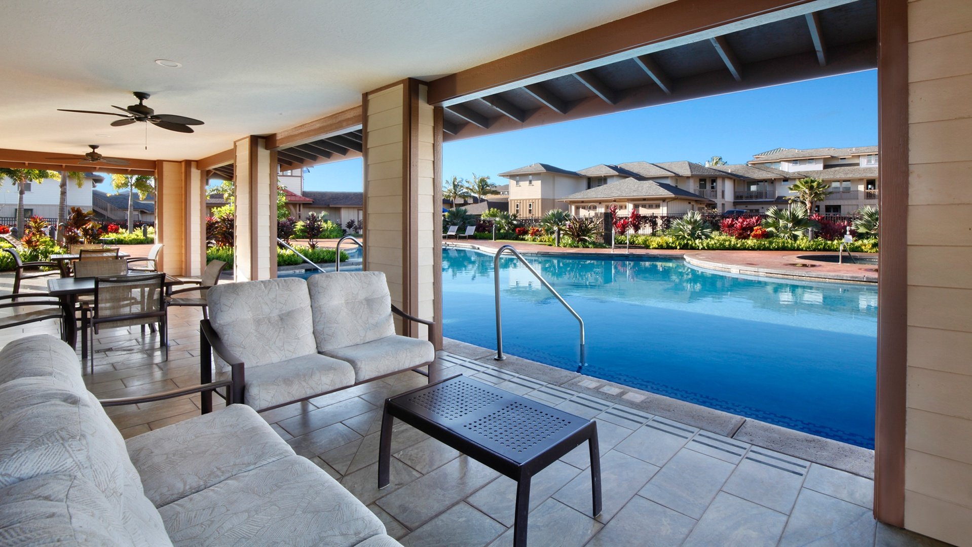 Poolside cabana with lounge seating overlooking the resort pool