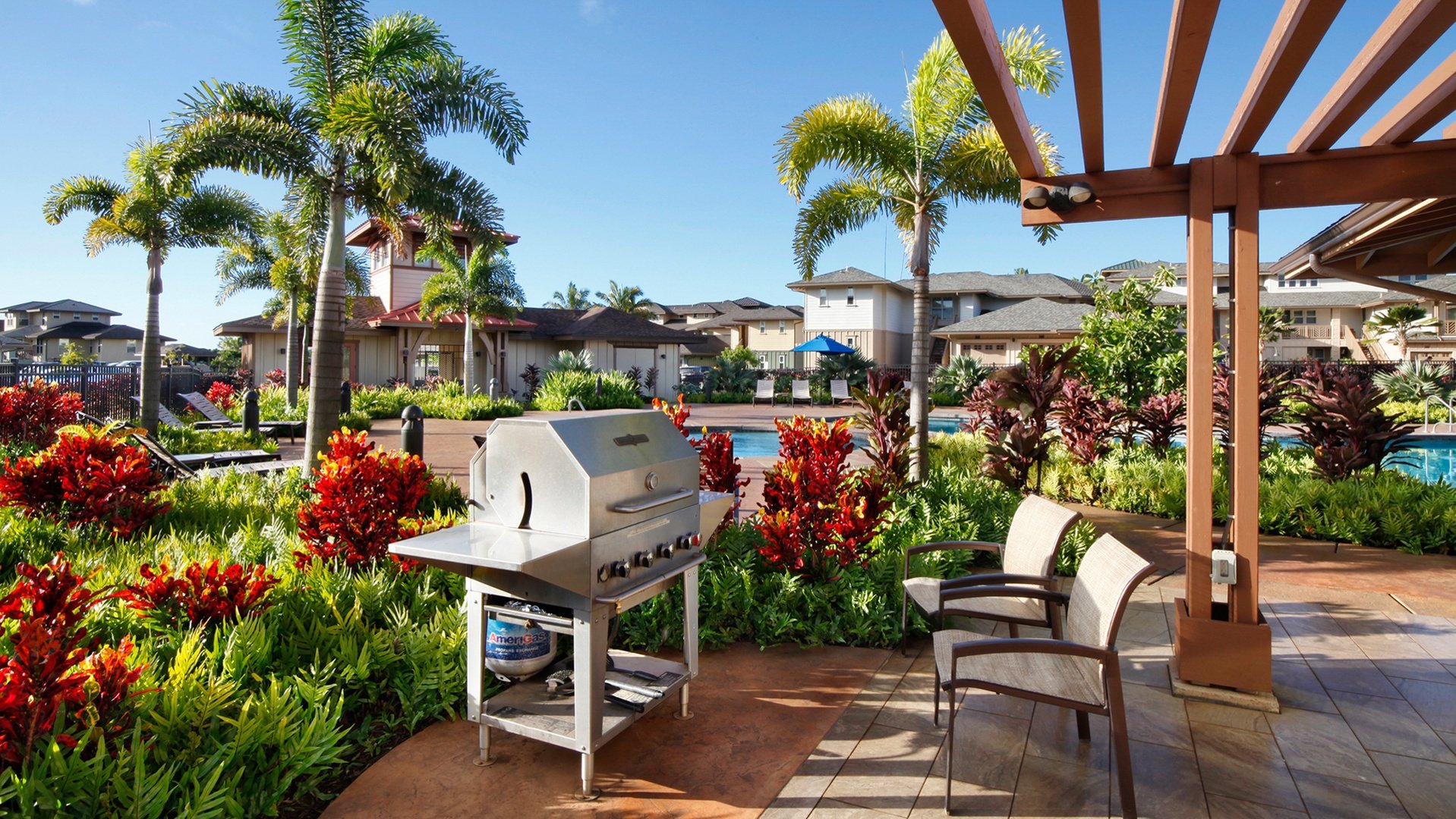 Gas BBQ grills with covered seating at the resort pool
