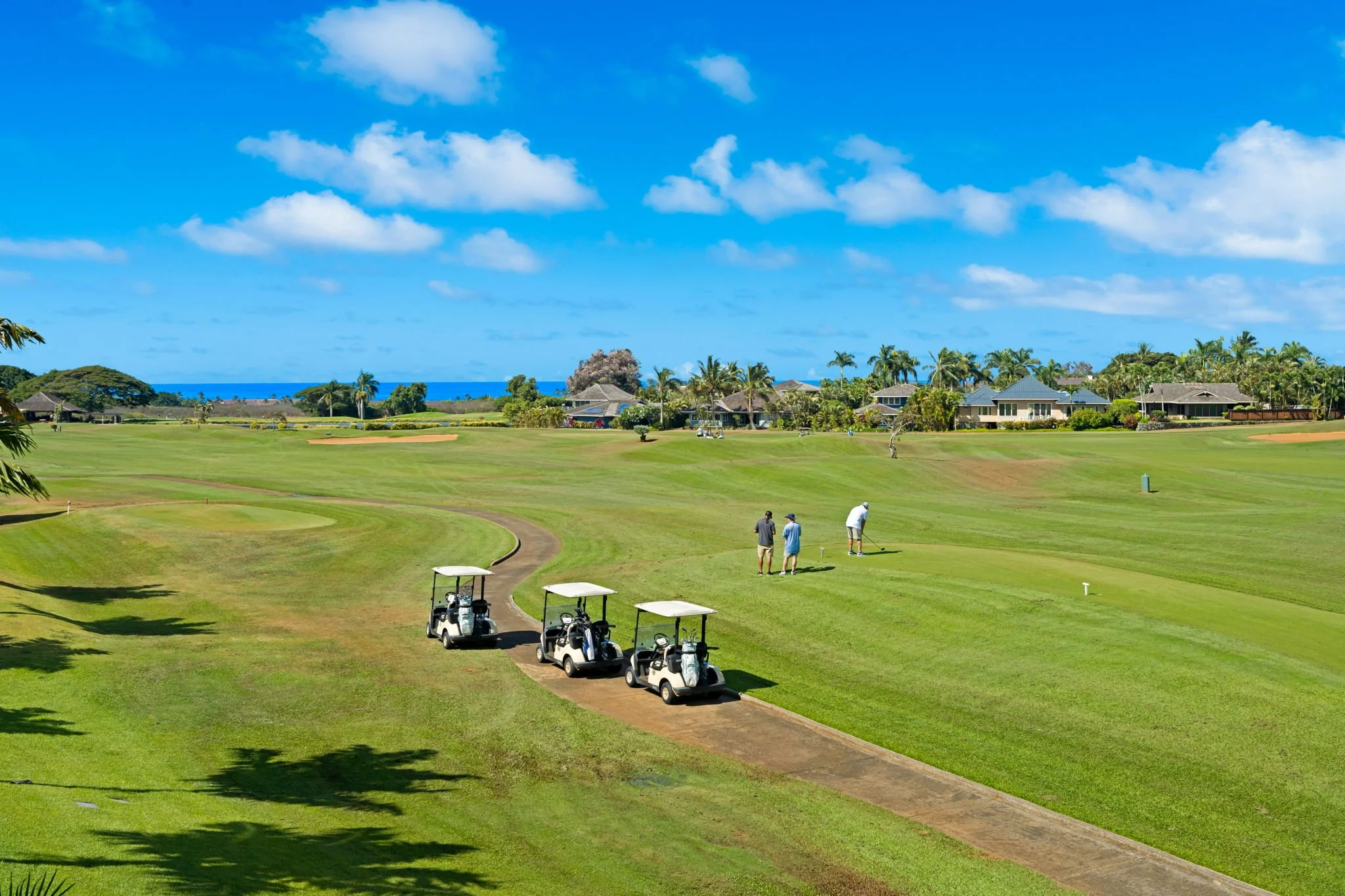 Golfers on the Kiahuna Golf Course fairway — steps from your lanai