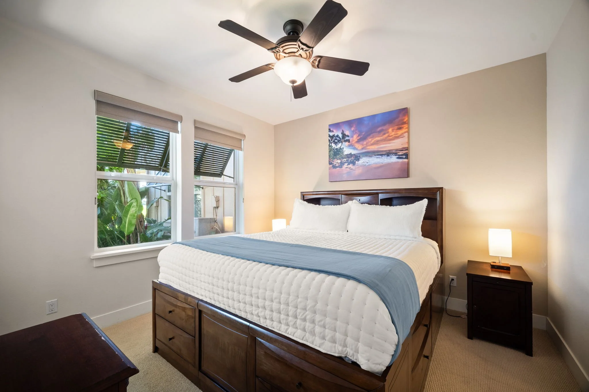 Master bedroom with king bed, ceiling fan, and garden views
