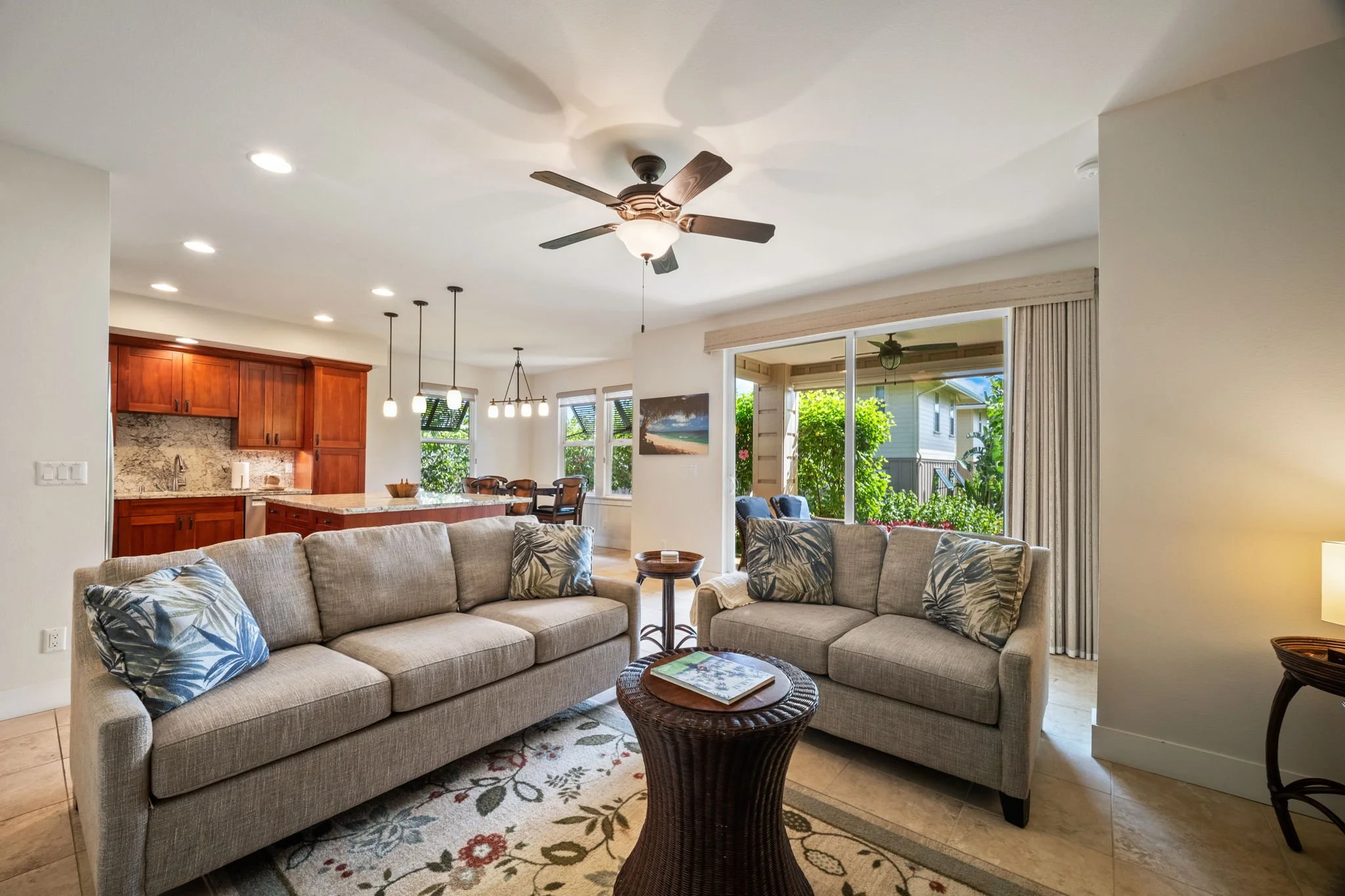Spacious living area with sleeper sofa and ceiling fan