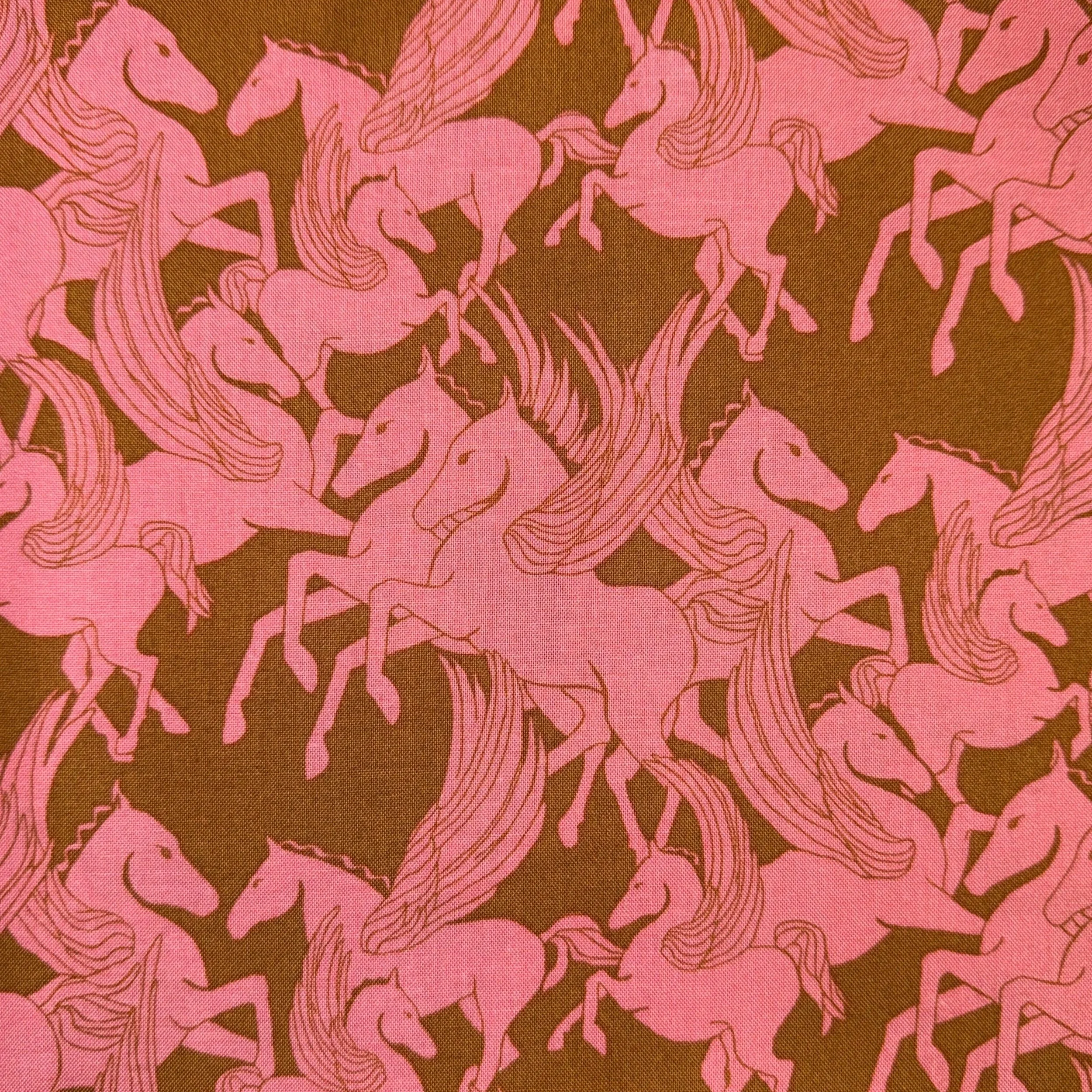 Pattern of pink unicorns with flowing manes and tails on a brown background.