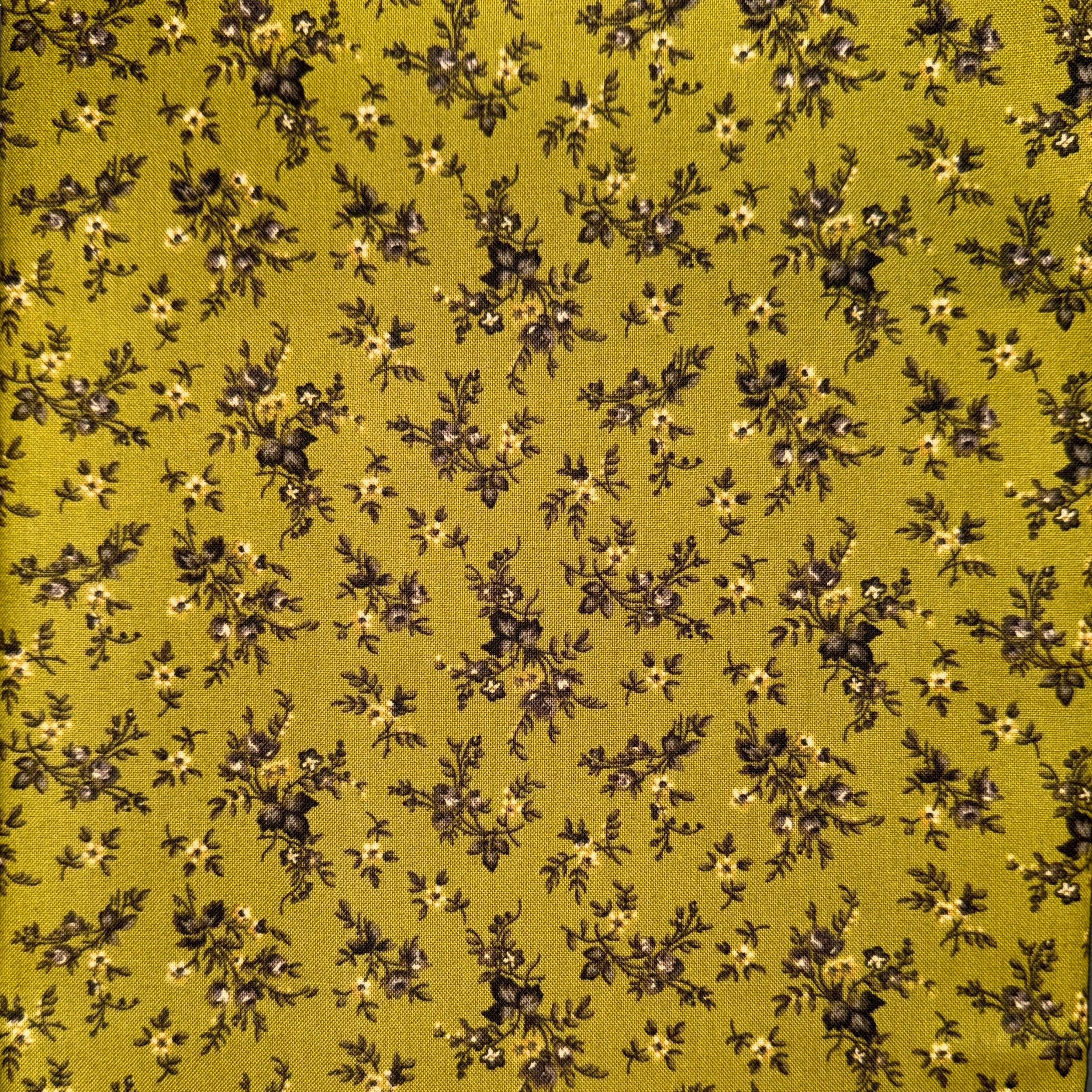 Pattern of small black flowers with white centers and green leaves on an olive green background.