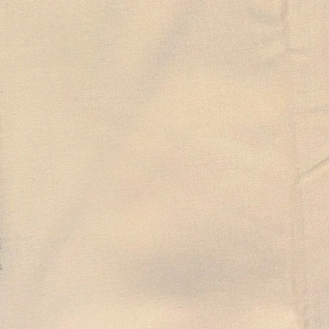 Close-up of a beige fabric surface.