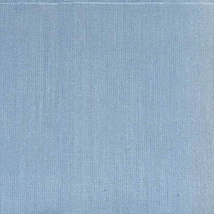 Close-up of a light blue fabric with a textured weave pattern.