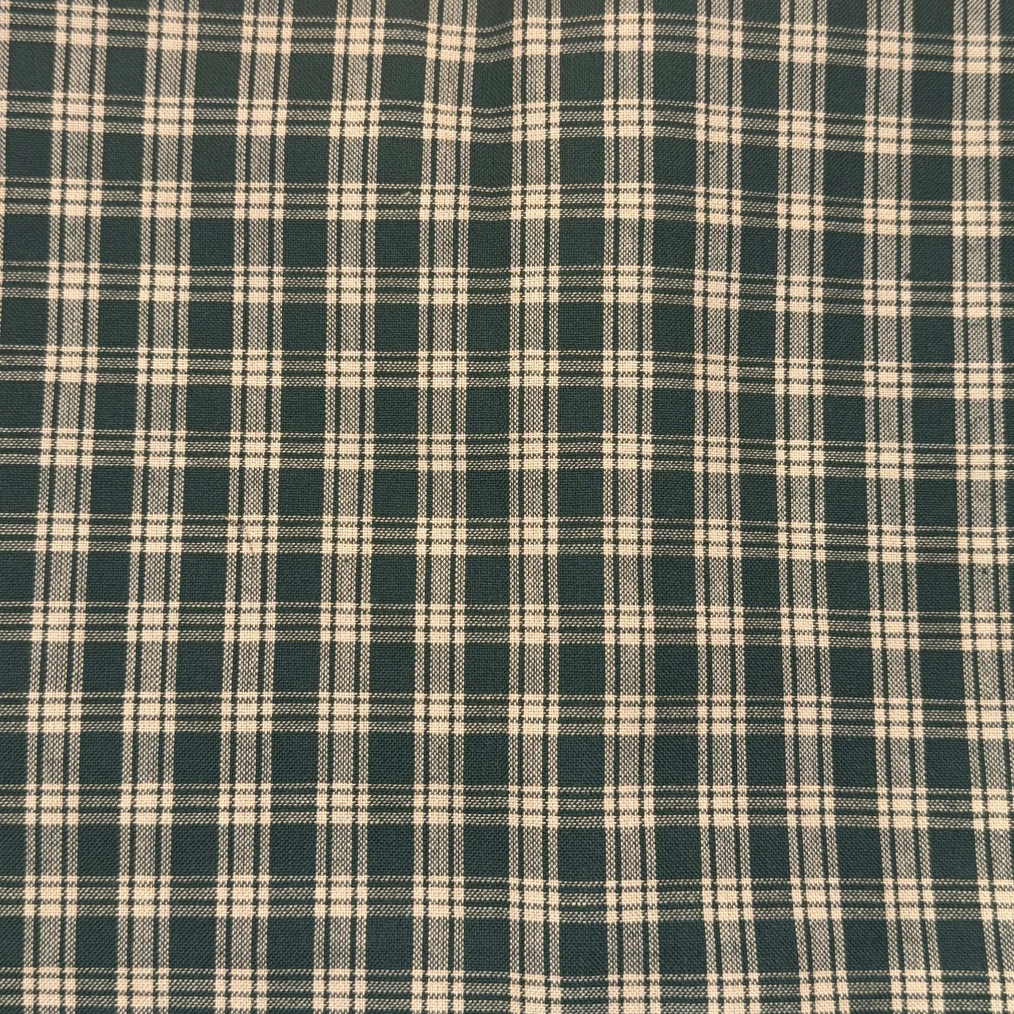 Close-up of green and beige plaid fabric pattern.