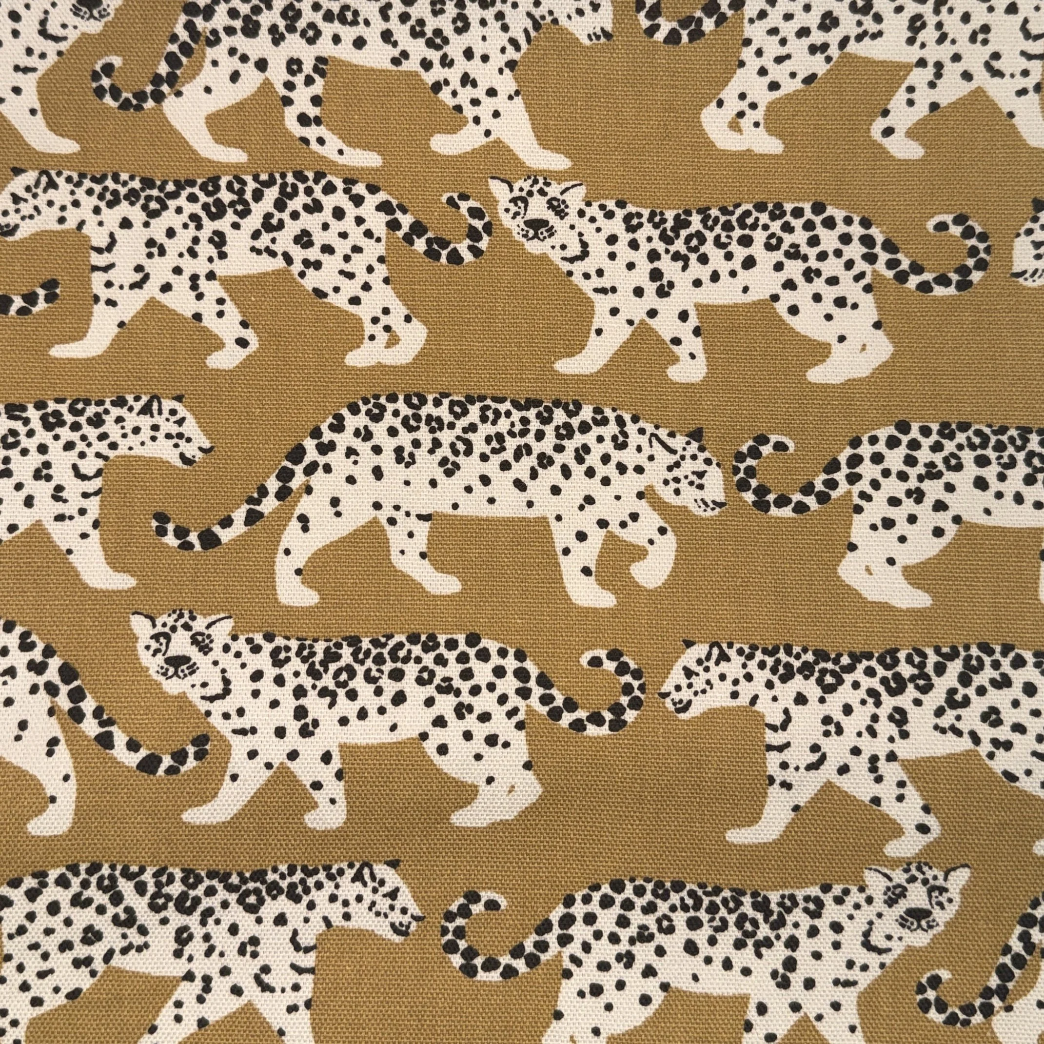 Pattern of white leopards with black spots on a brown background.