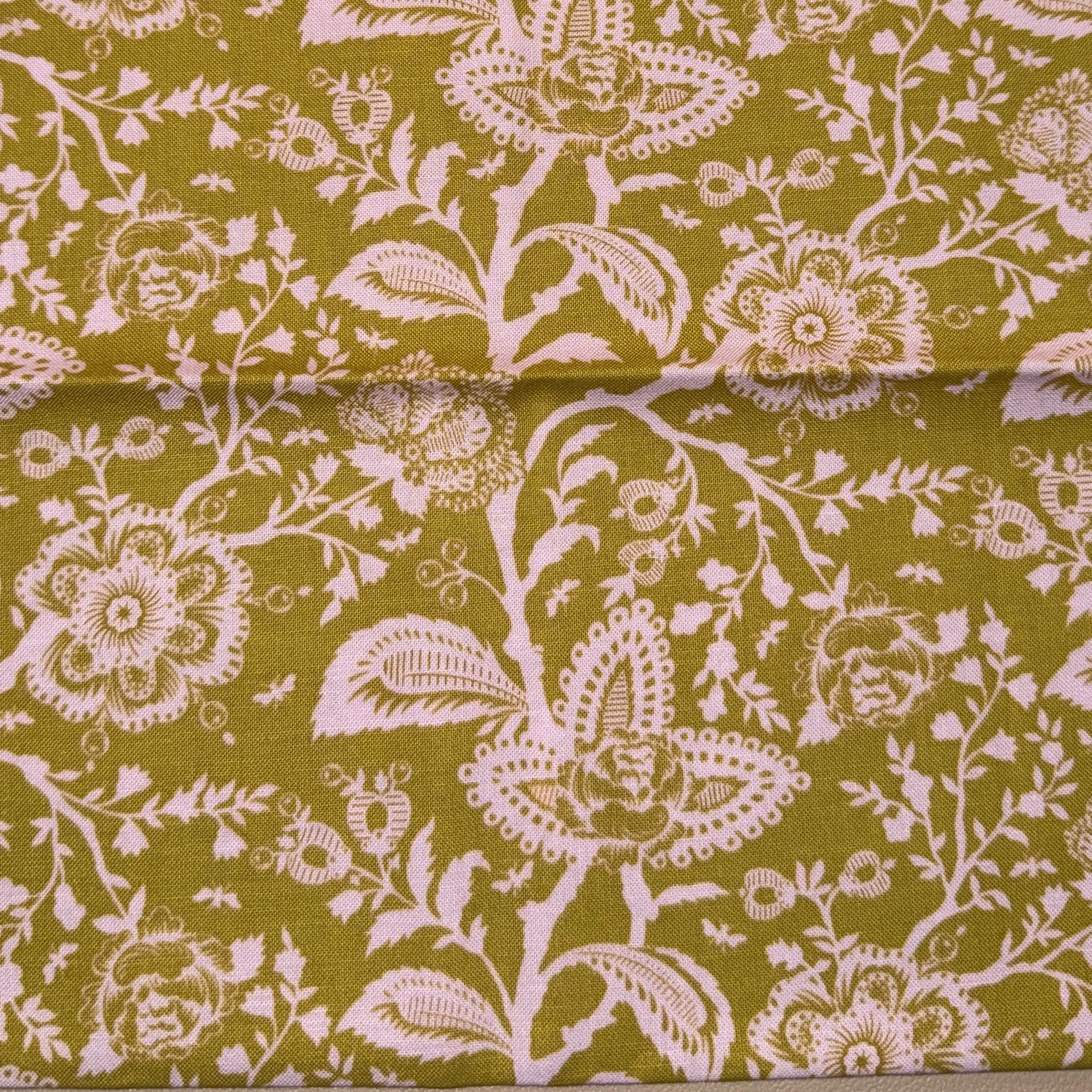 Green fabric with a pink floral and butterfly pattern.