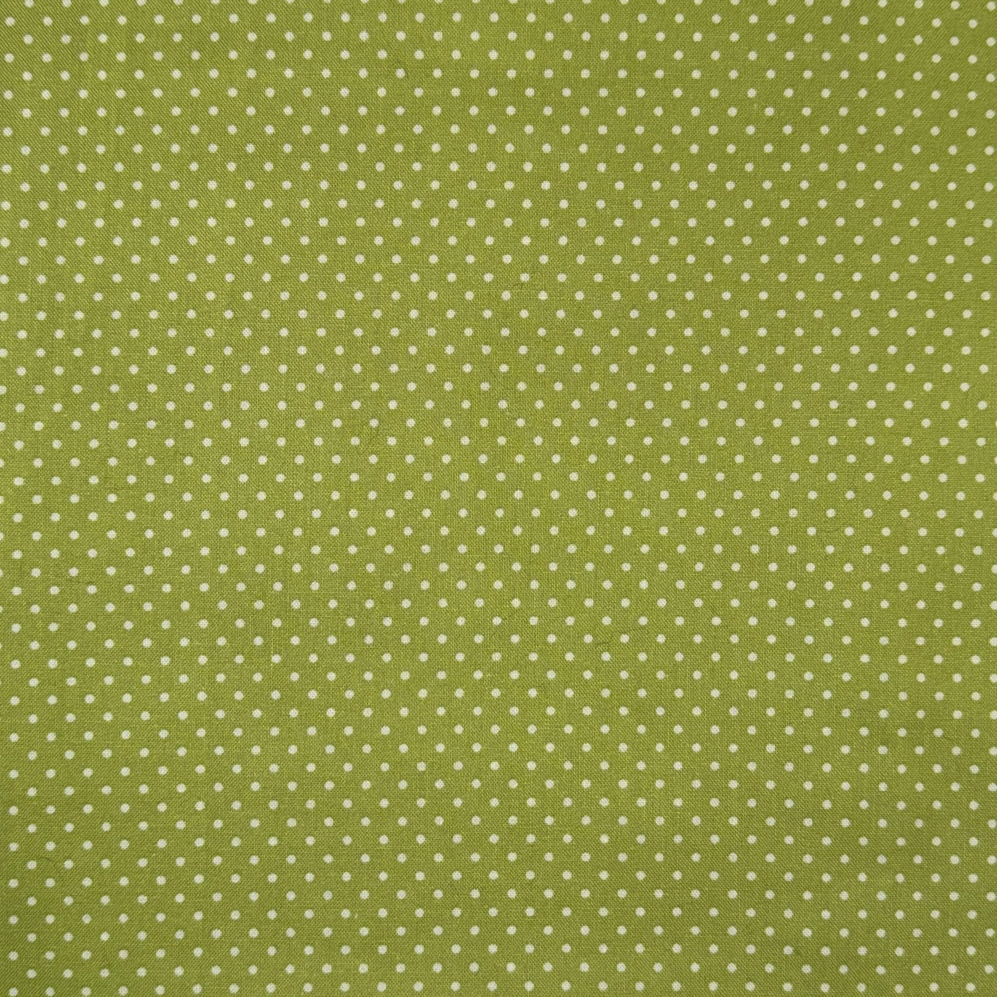 Green fabric with small white polka dots pattern.