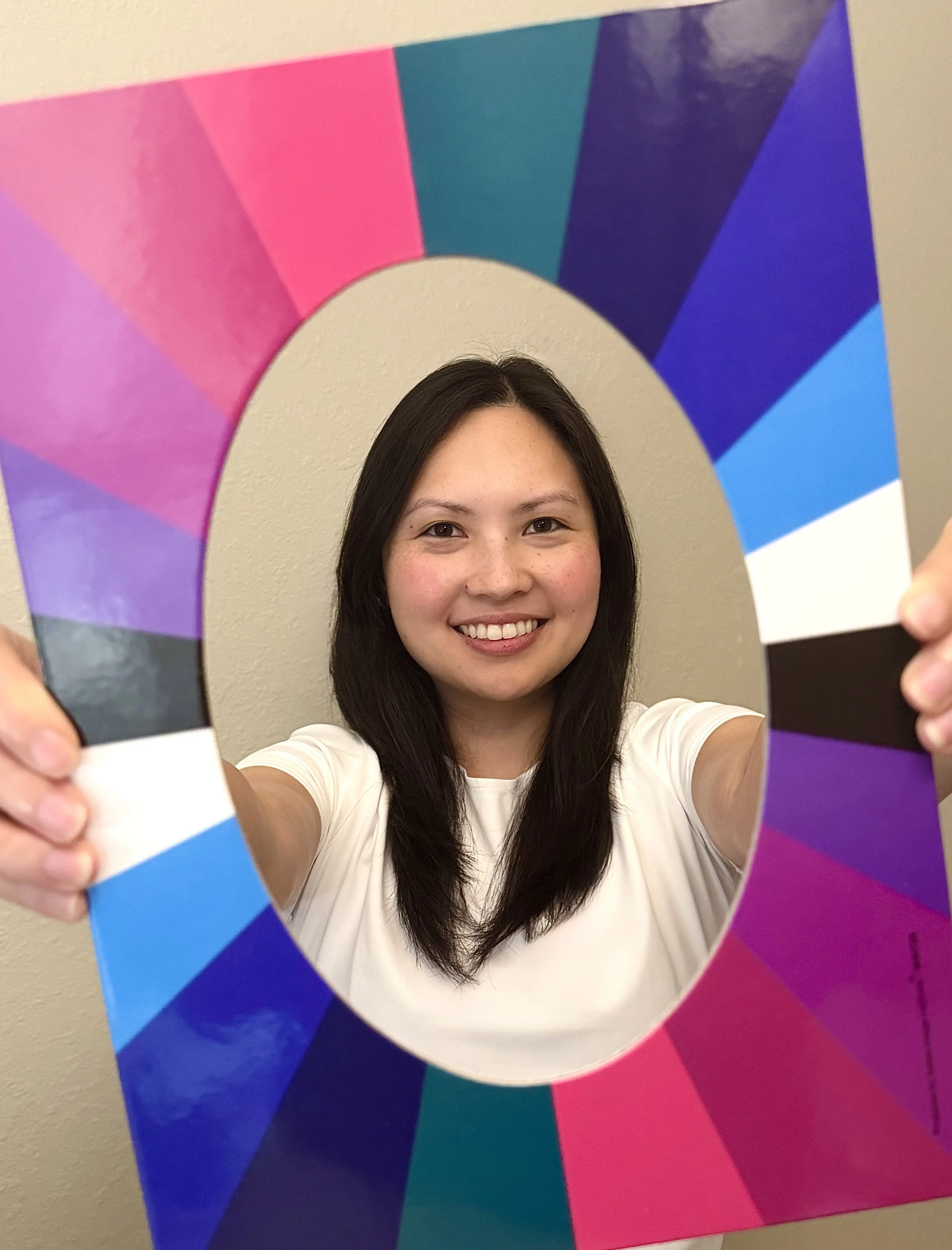 Bing, certified color analyst in Fairfax VA holding a seasonal color palette frame during a color analysis session