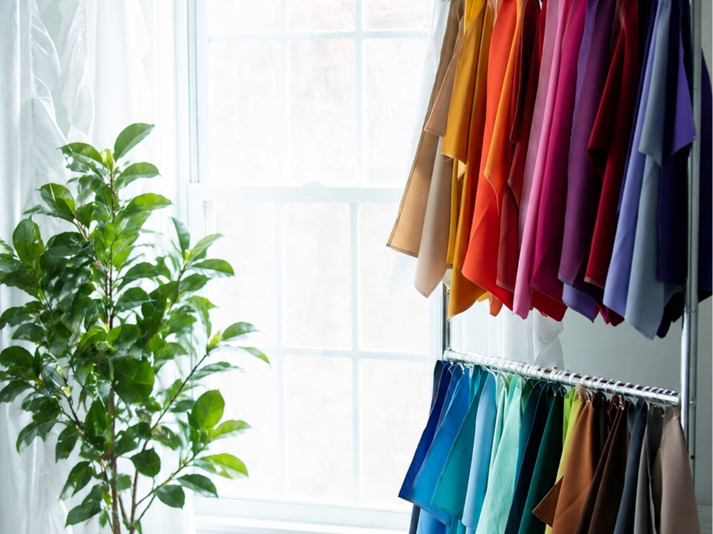 Colorful fabric drapes on a rack used for seasonal color analysis sessions in Fairfax VA by Color Analysis with Bing
