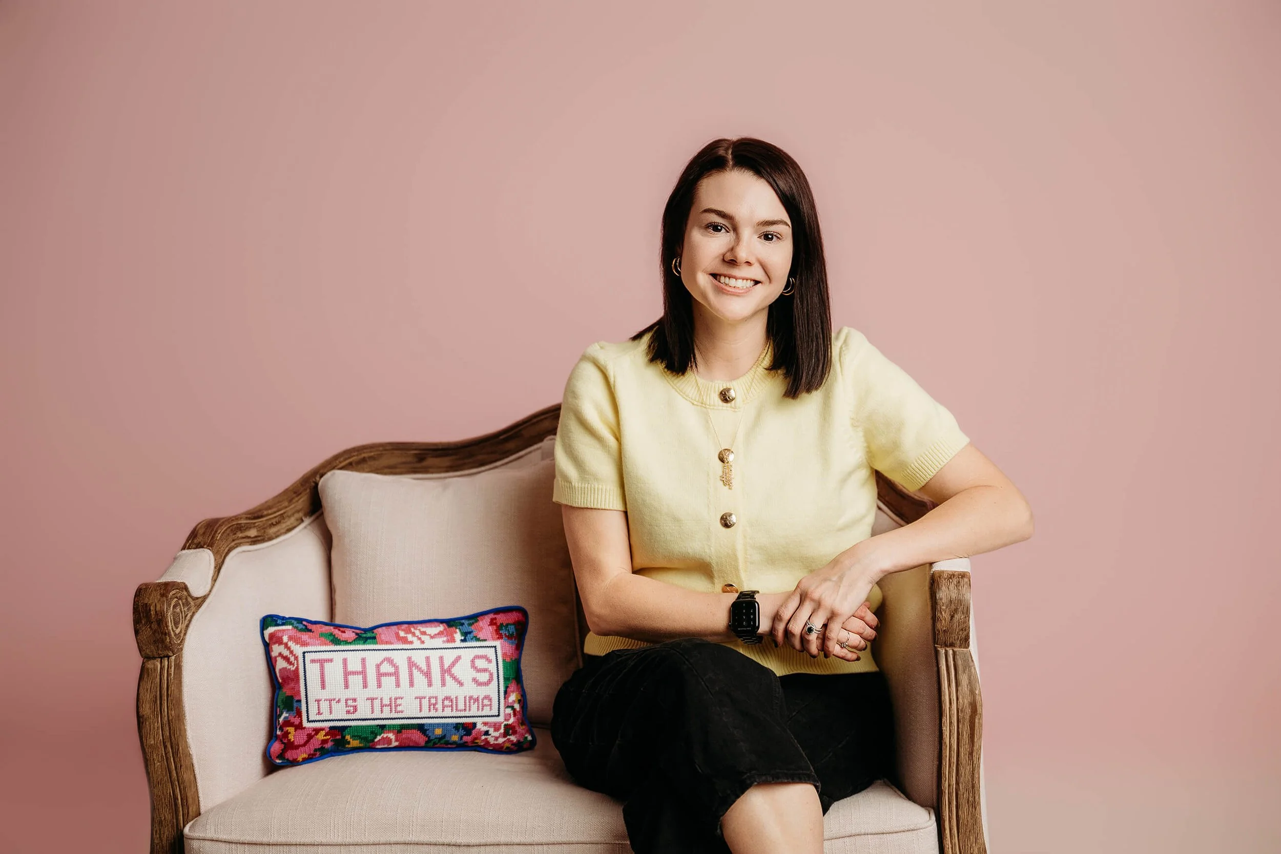 Dr. Hillary Ammon sitting on a pink couch