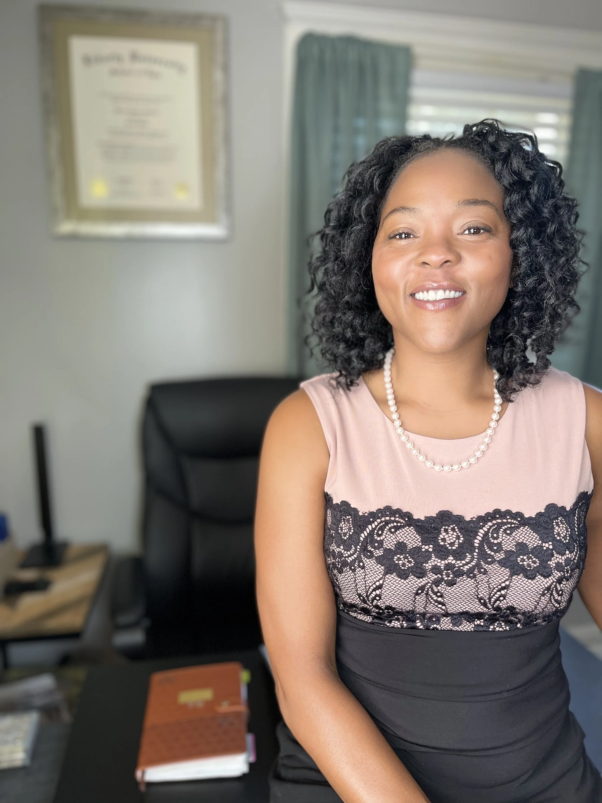 Sheenayvonne sitting on her desk