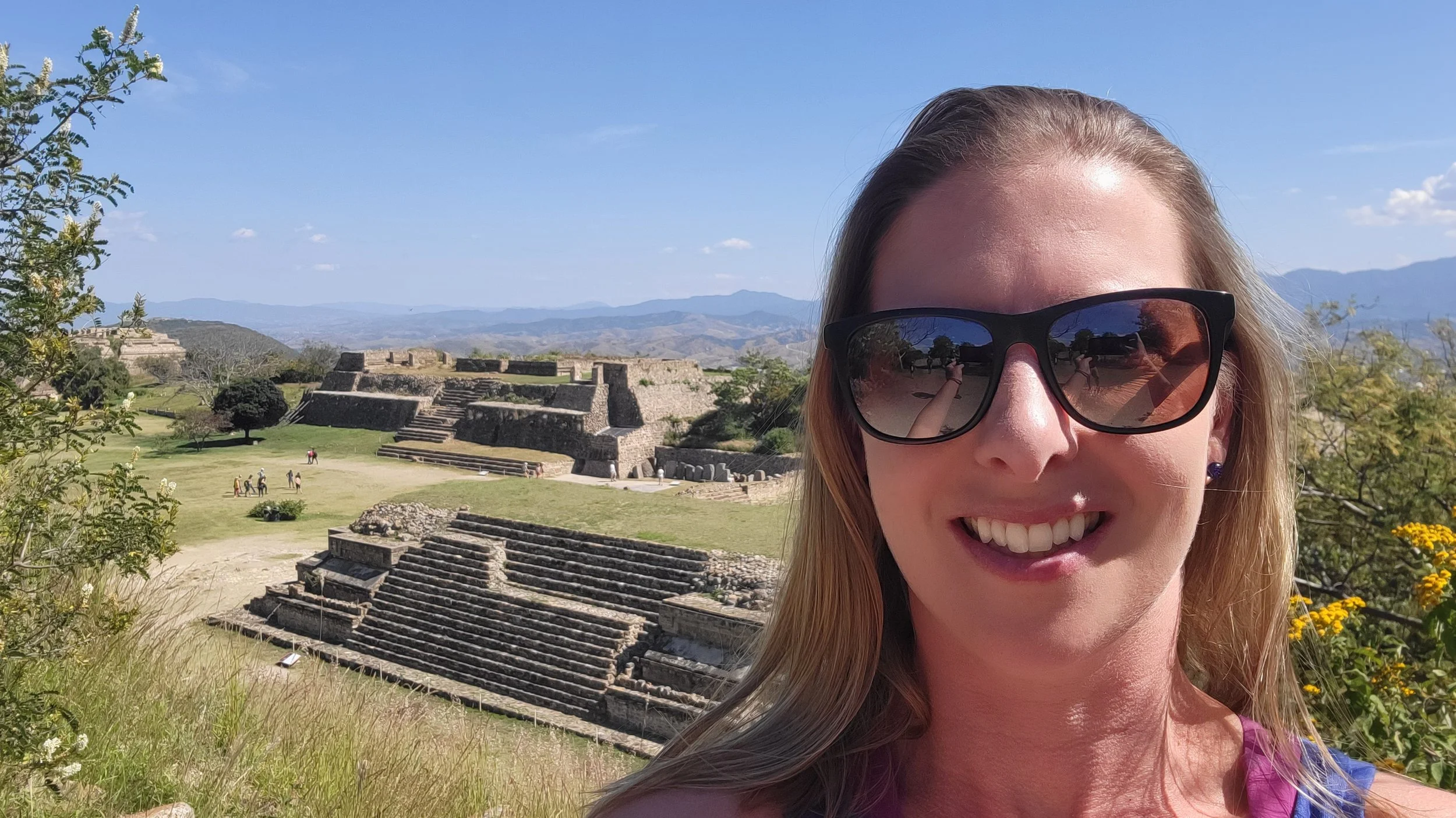 Alyson in sunglasses at ancient stone ruins on a family trip