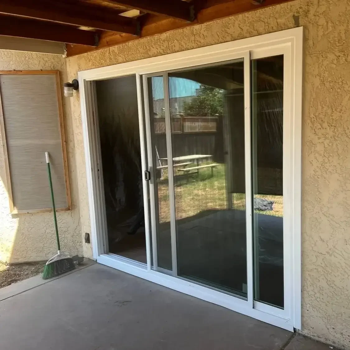 Large white vinyl sliding glass door replacement installed on a residential patio in Stockton, California.
