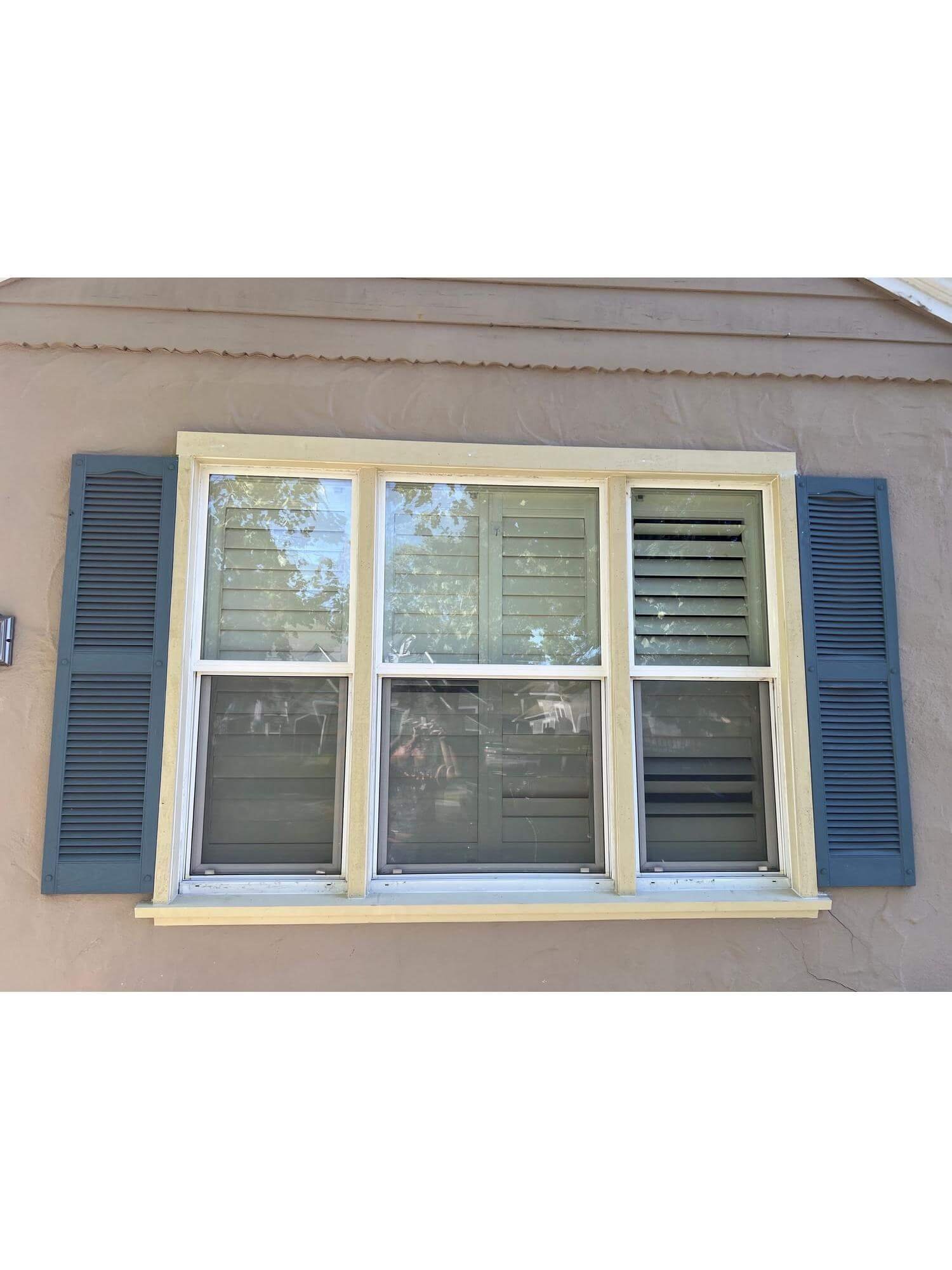 Custom exterior window trim installation with decorative shutters on a residential home in Stockton, California.