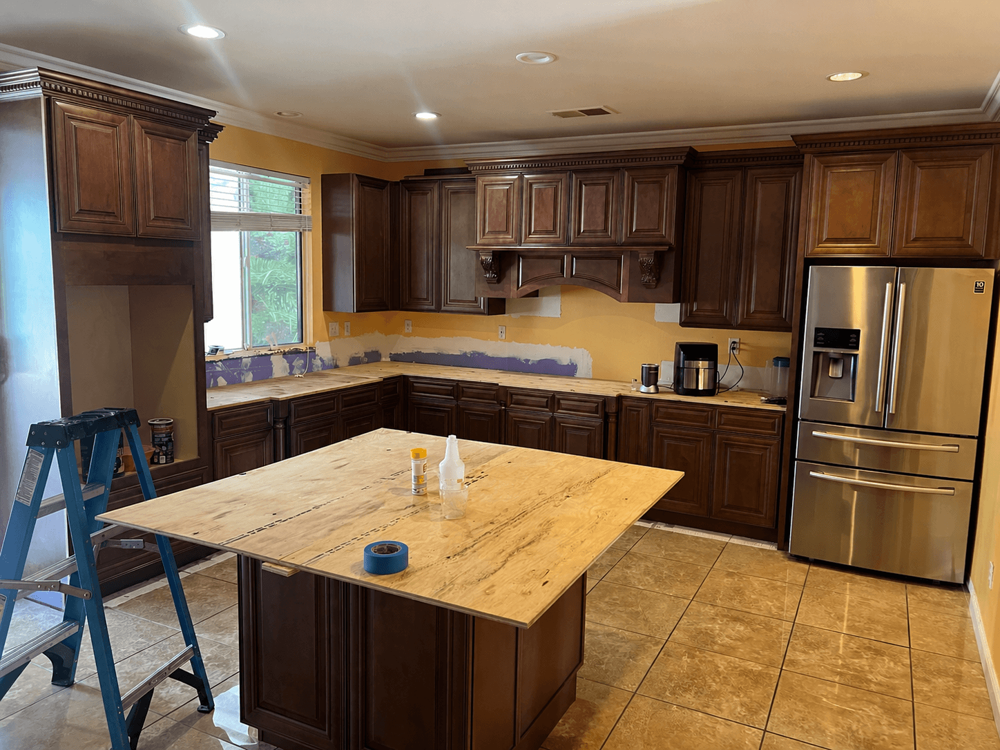 Custom kitchen cabinet installation with decorative crown molding, kitchen island, and remodeling work by All About Carpentry Inc. in Stockton, California.  Section Title