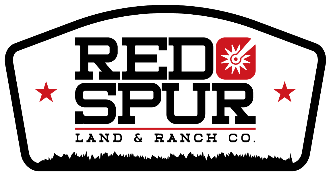 Logo for Red Spur Land & Ranch Co. with black, red, and white colors, featuring stars and a stylized spur design.