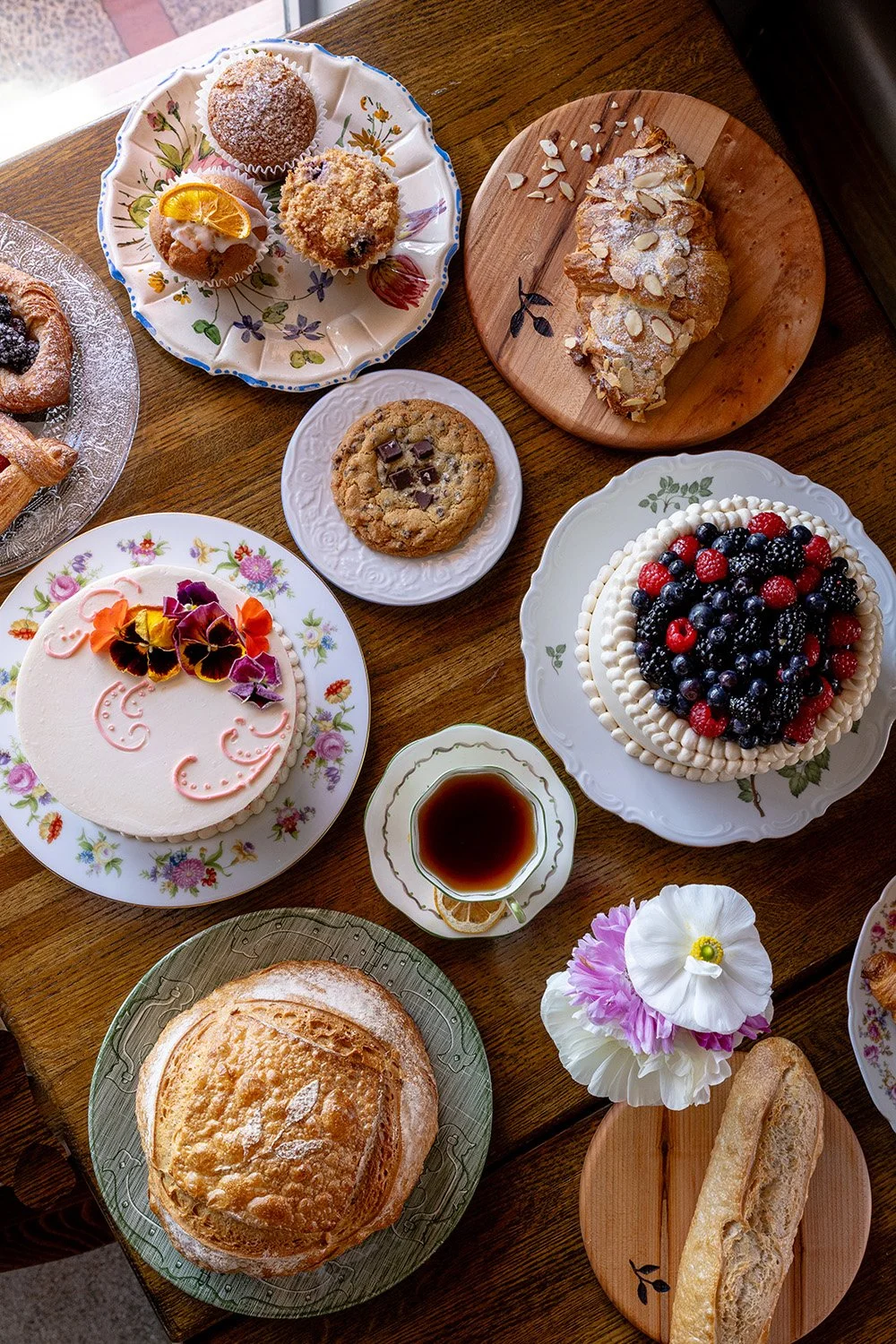 table top with breads, pastries, and special event cakes
