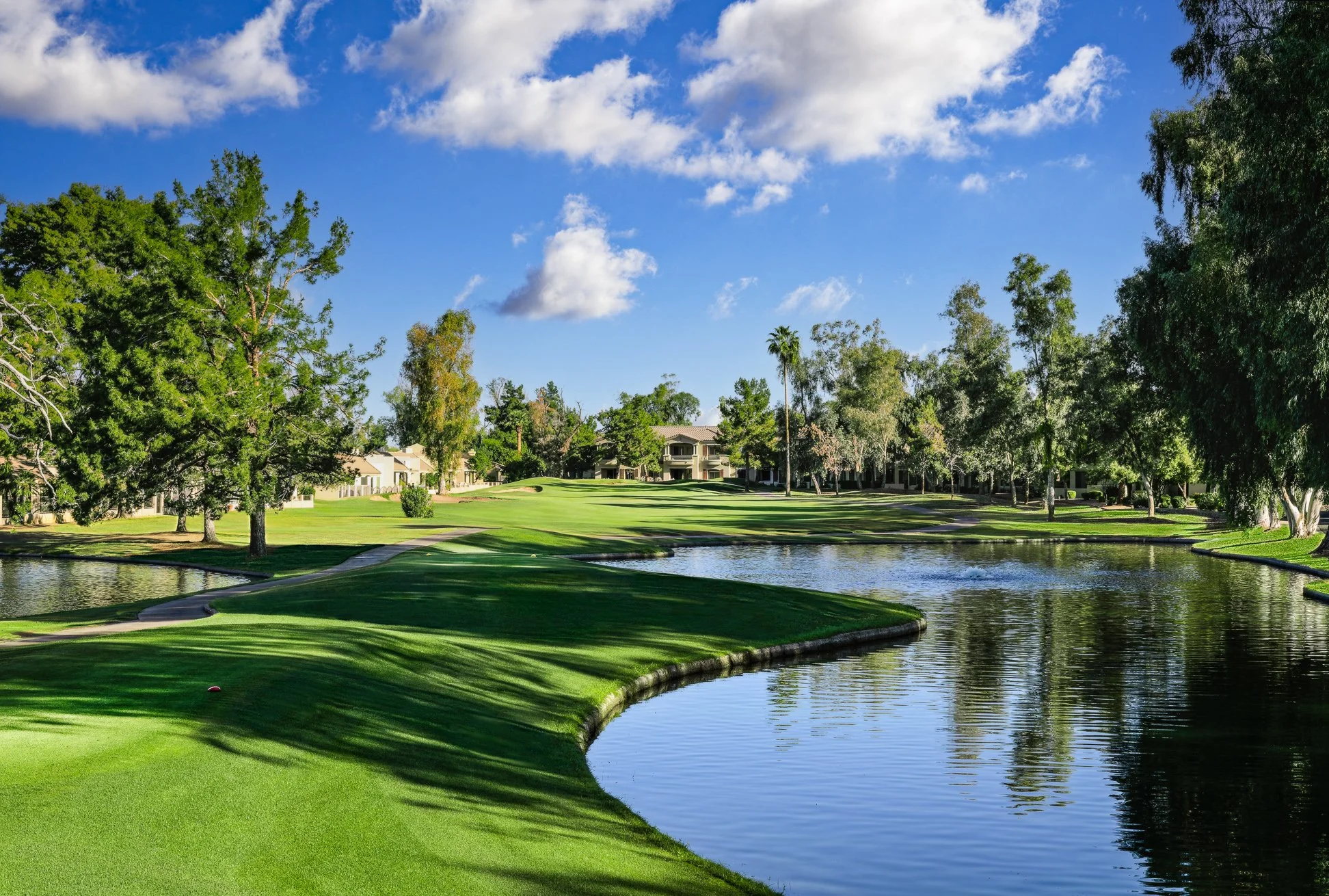 A scenic view of a pond and fairway at Scottsdale Country Club in Scottsdale, Arizona.