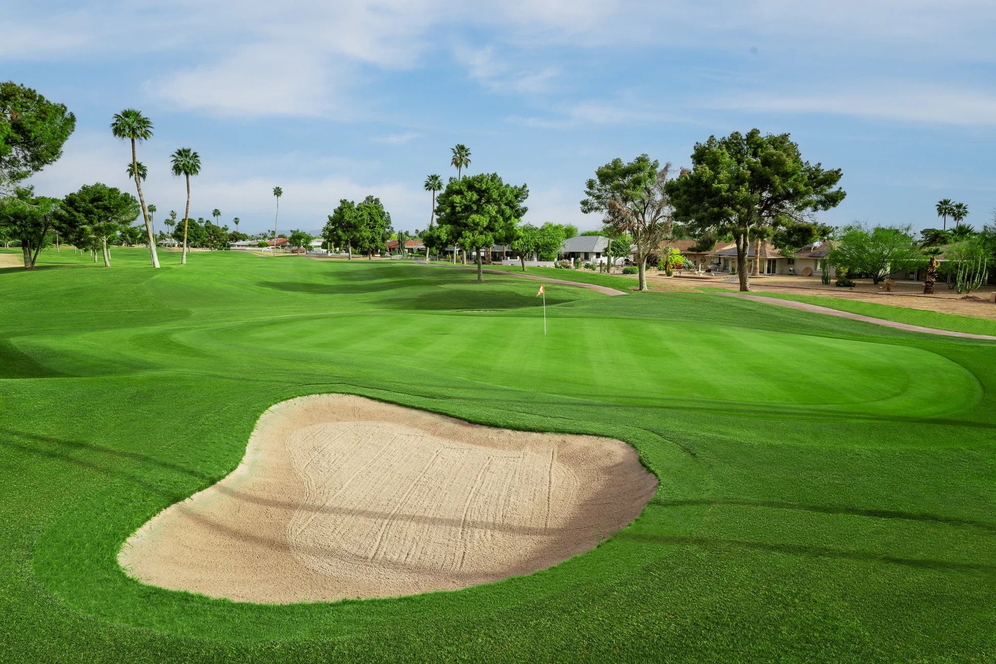 View of a putting green and sand bunker on the golf course at Briarwood Country Club in Sun City West Arizona.