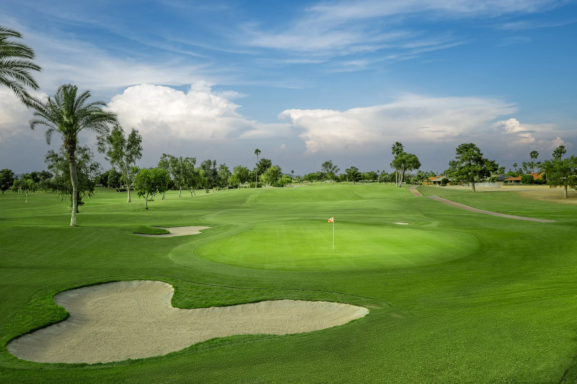 View of a putting green and sand trap on the 18th hole of Briarwood Country Club in Sun City West Arizona.