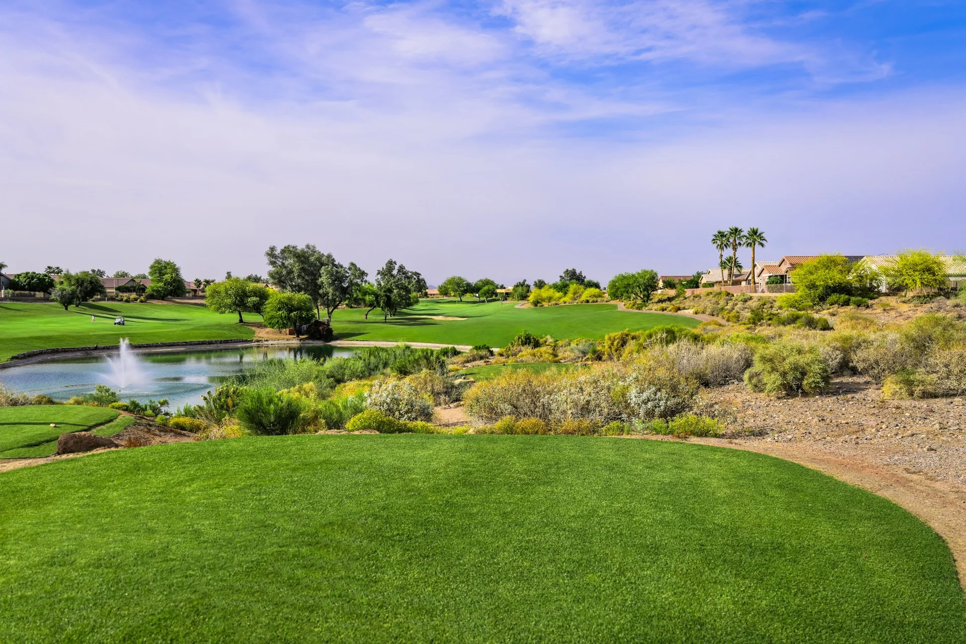 View of the tee box and fairway of the 17th hole at Coyote Lakes Golf Club in Surprise, Arizona.