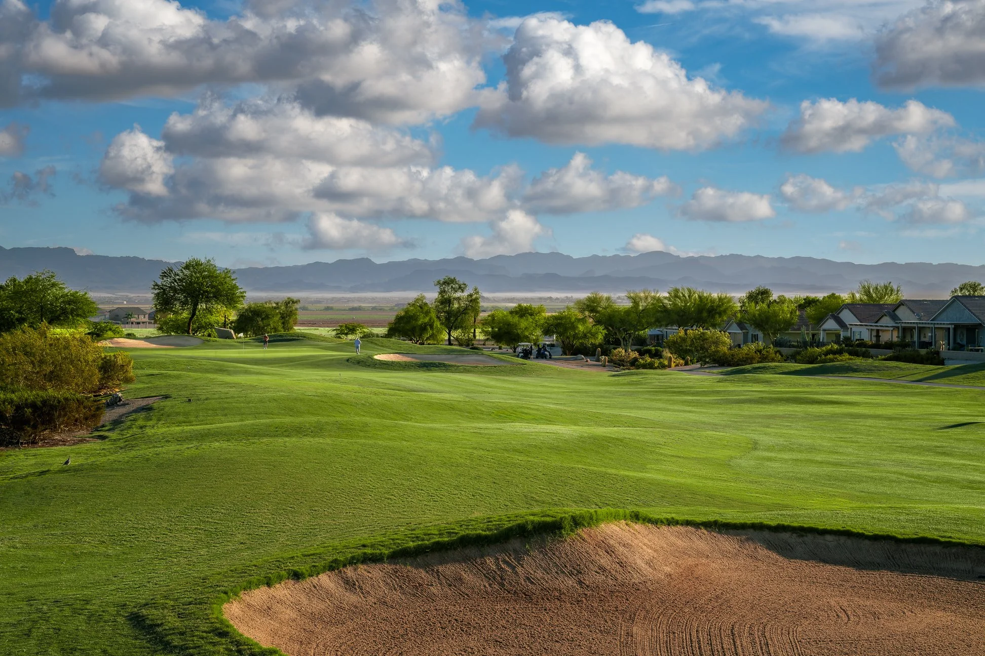 View of a sand bunker, fairway and blue sky on the 14th hole at San Tan Highlands Golf Club in San Tan Valley, Arizona.