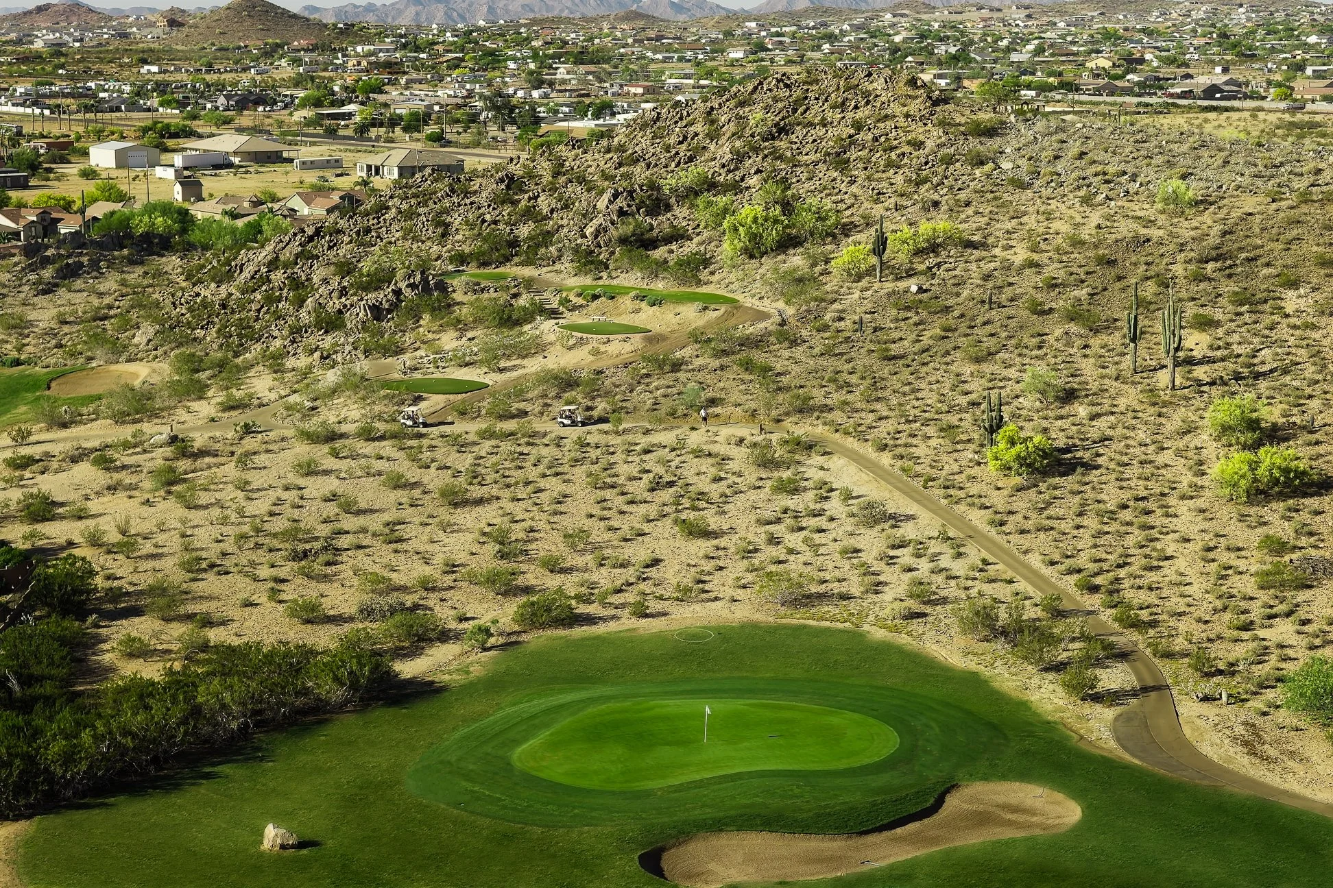 Aerial view of the desert and putting green on the golf course at San Tan Highlands Golf Club in San Tan Valley, Arizona.