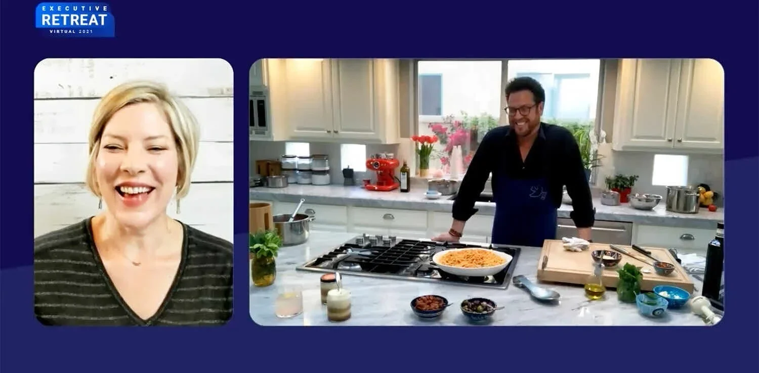 A virtual event titled 'Executive Retreat 2021' showing a woman talking on the left and a man cooking in a kitchen on the right.