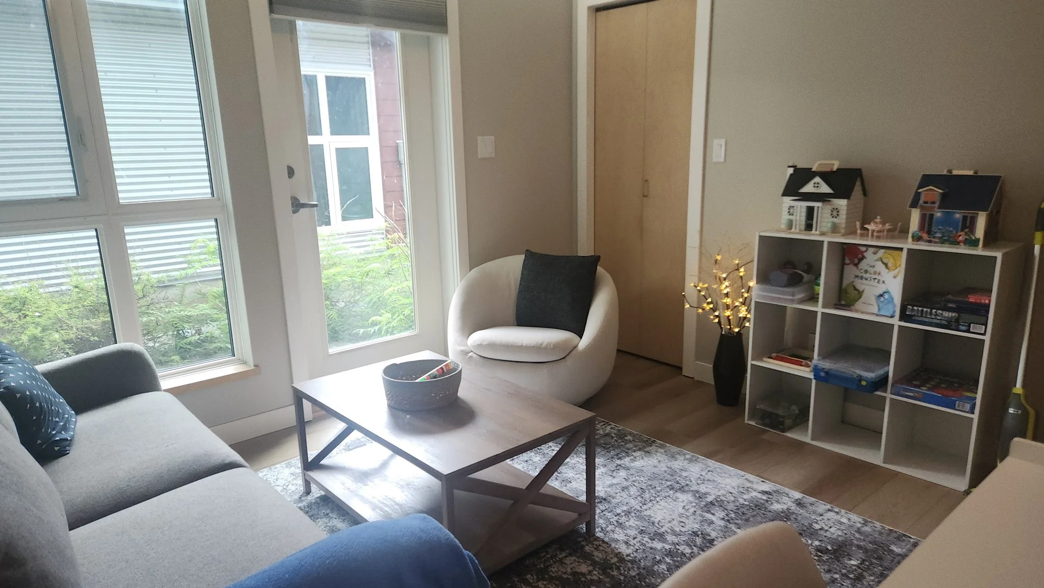 Office space with toys, couch and large window