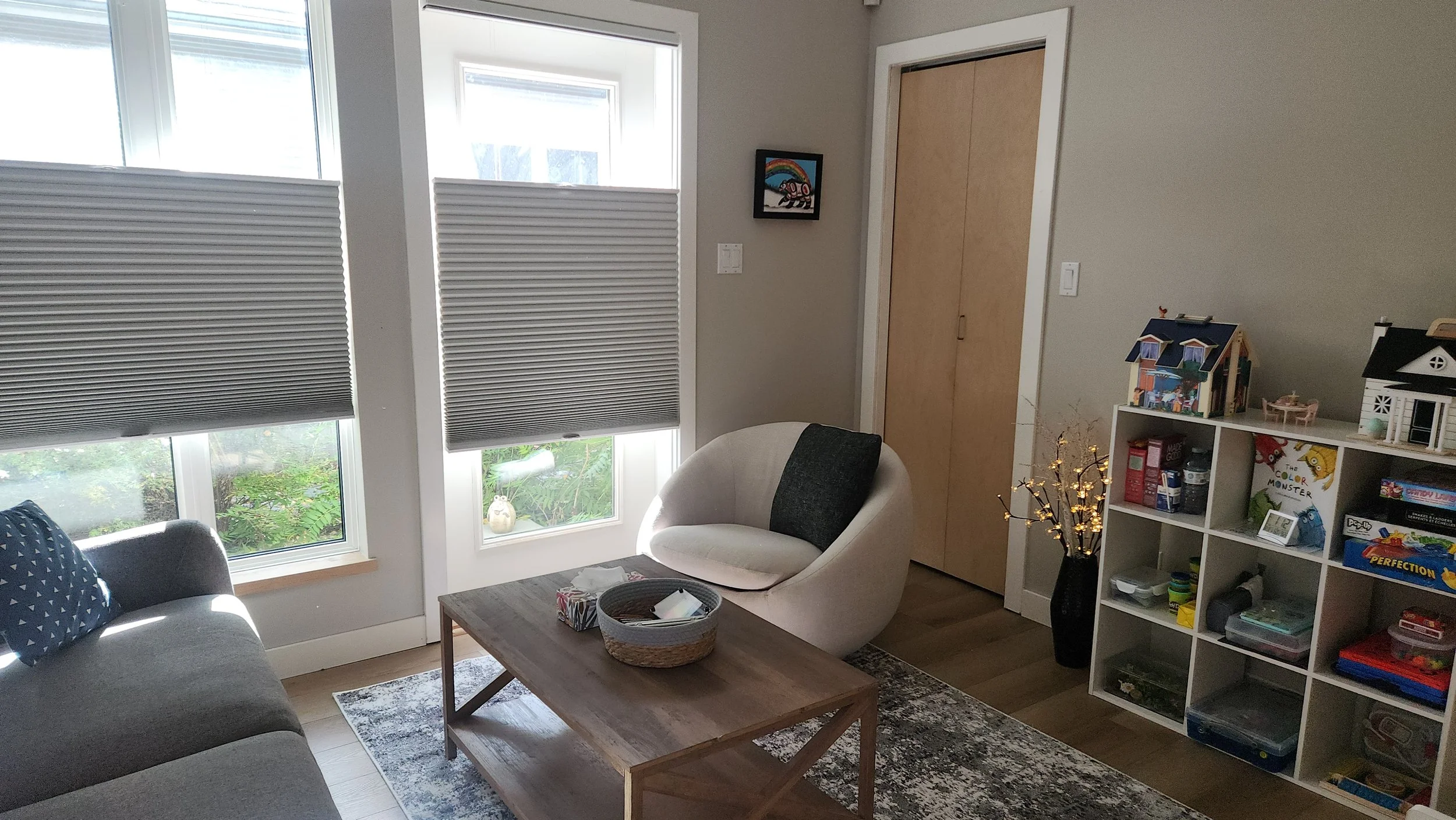 Play therapy office with table, chair and toy shelf