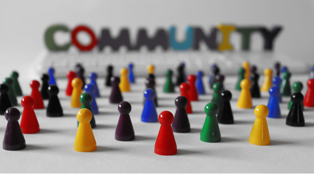 Colourful pegs and the word community in the background