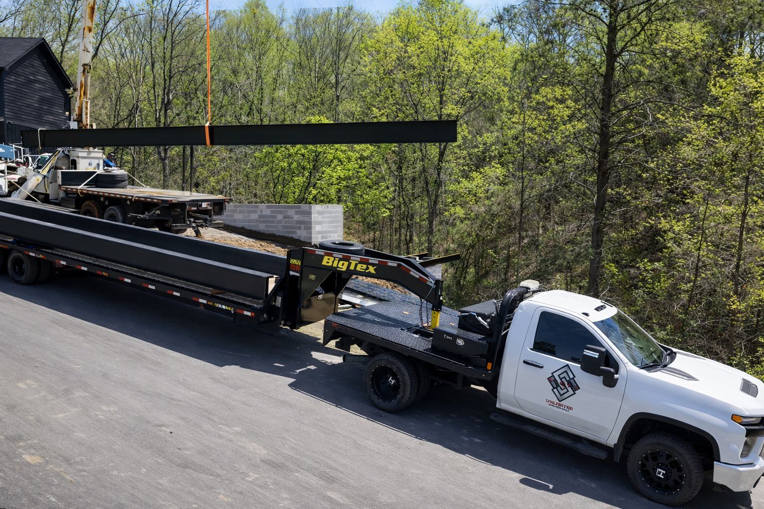 Crane lifting steel beams for structural installation at East Tennessee construction site.