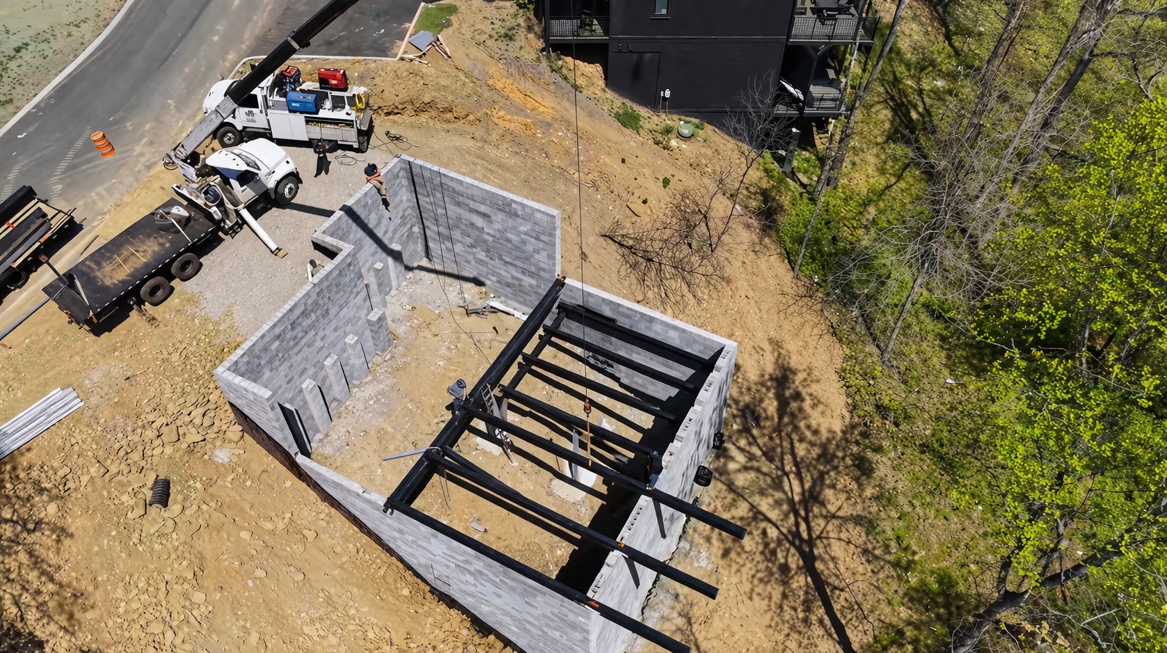 Structural steel support beams integrated with concrete foundation at East Tennessee job site.