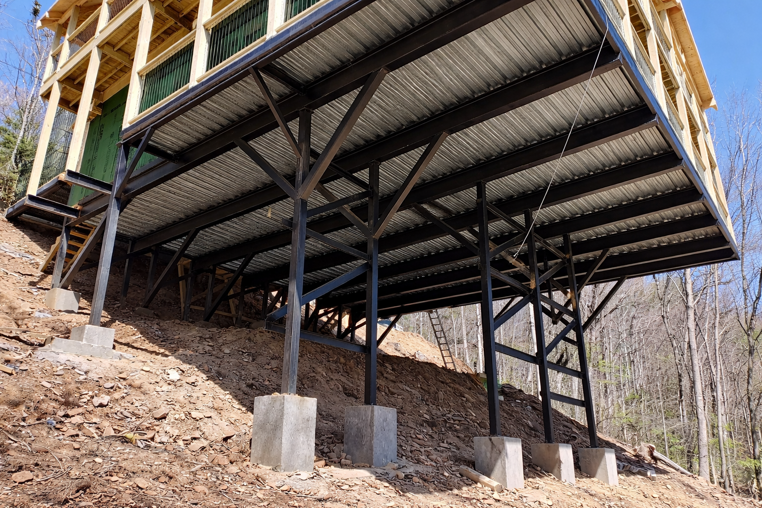 Hillside construction with steel support columns and elevated structure in Gatlinburg TN.