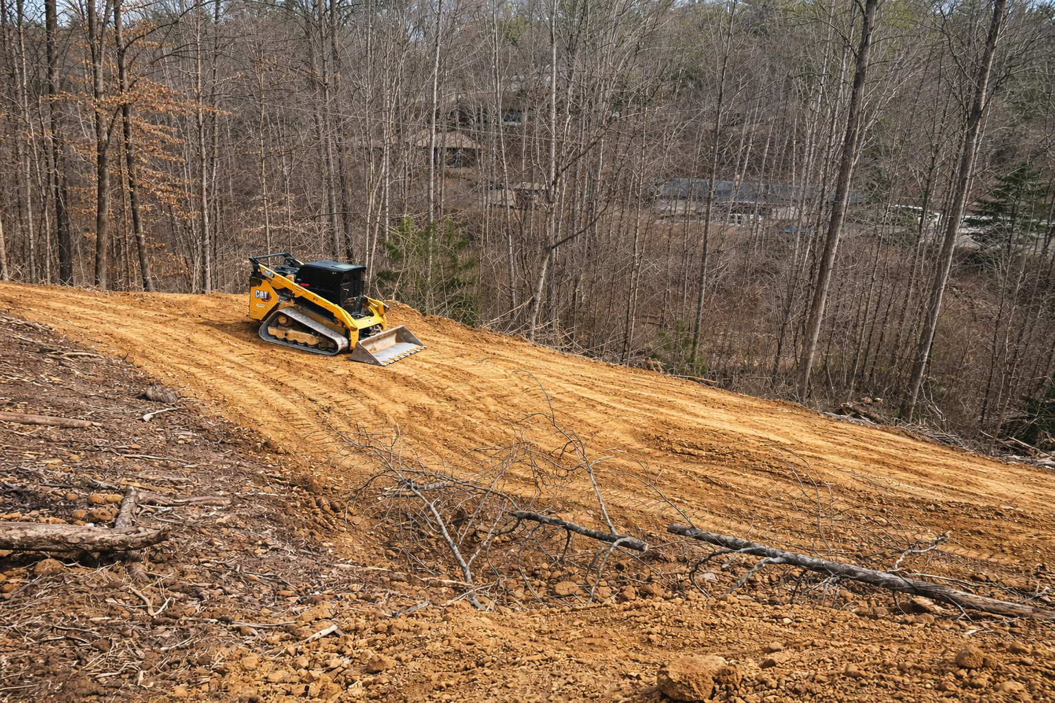 Land grading and clearing for construction site in wooded East Tennessee area.