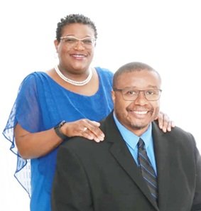 Dr. Mackins and his wife Erica of 24 years smiling in a family portrait.