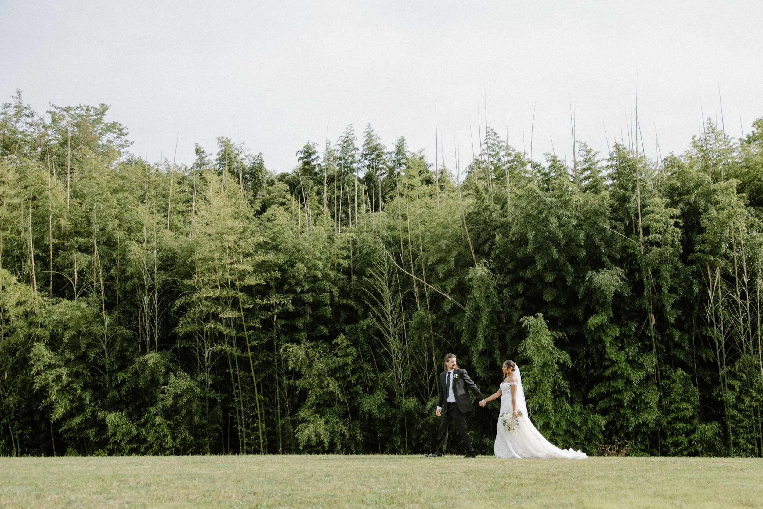 Bride and groom walking the grounds of Camelot Meadows wedding venue outside of Charlotte NC