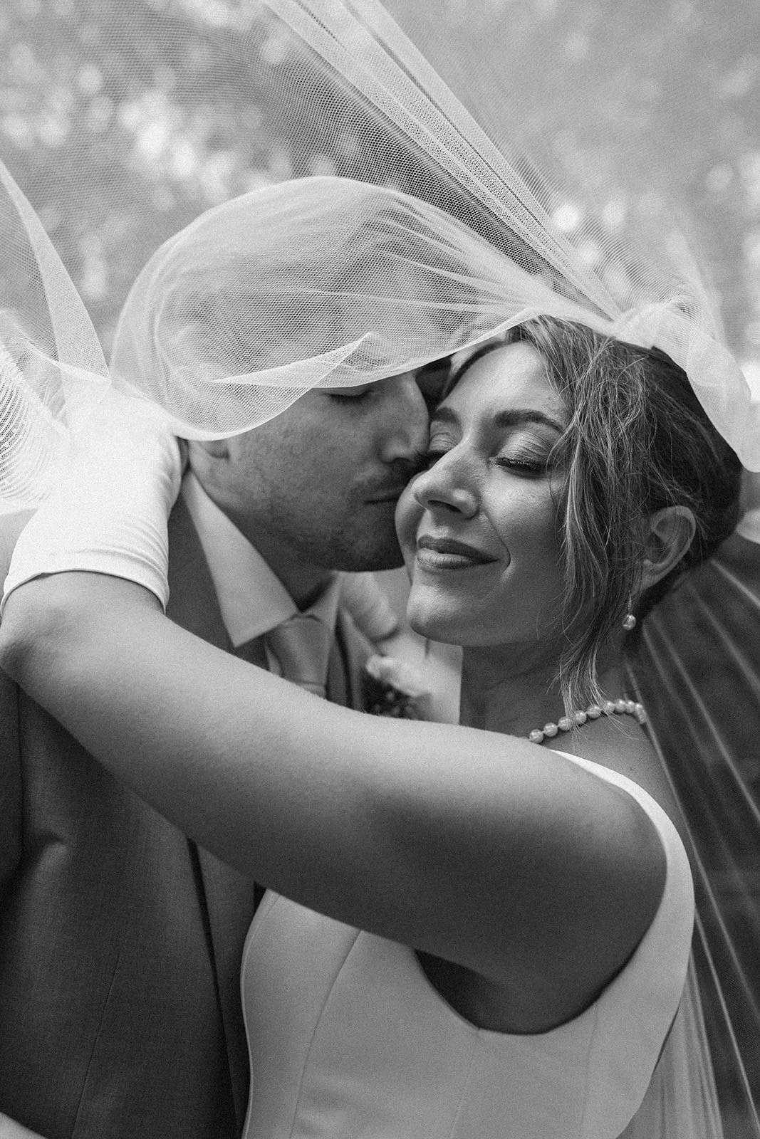Bride and groom embracing on wedding day