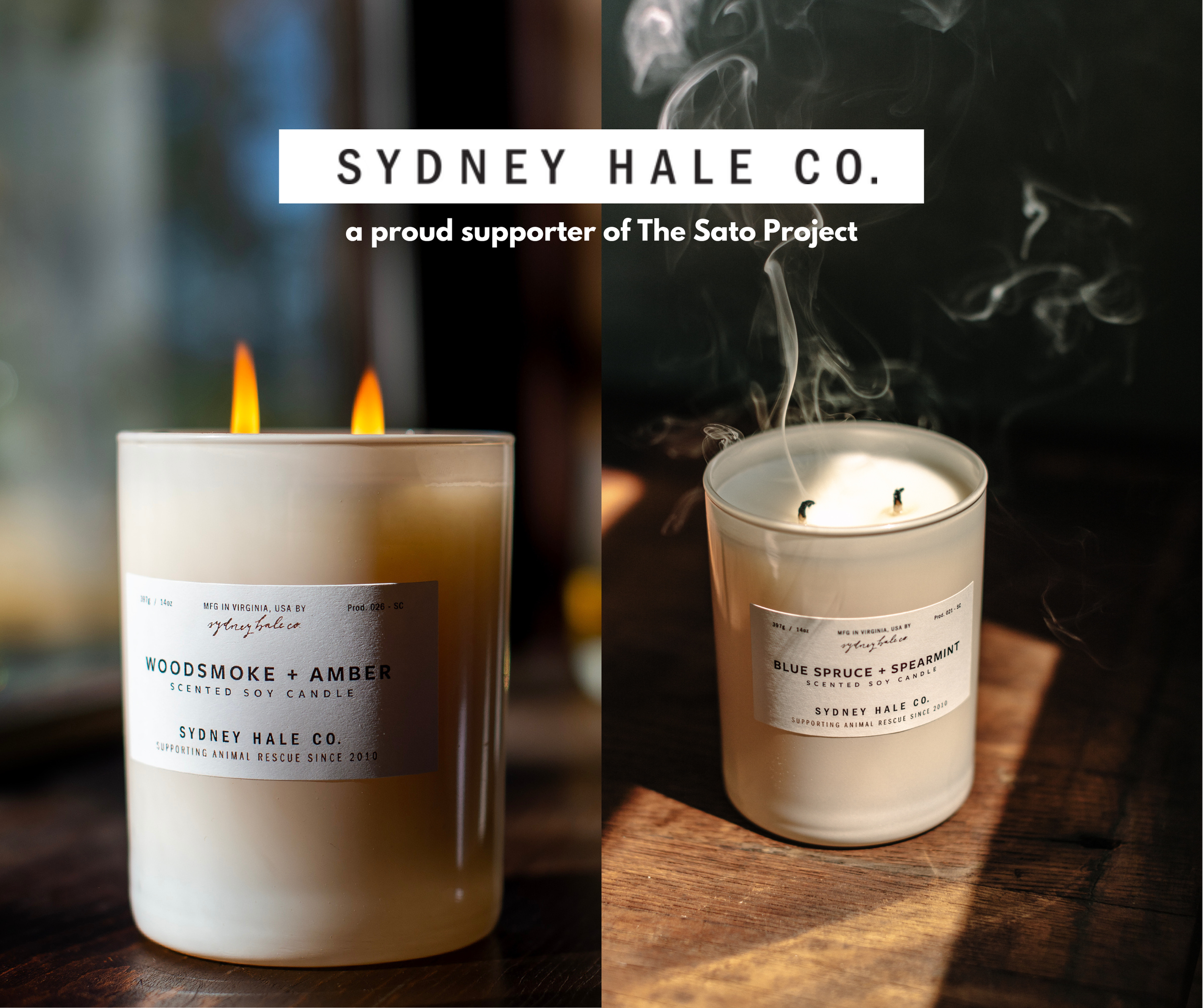 Two candles in glass containers, one titled 'WOODSMOKE + AMBER' with two flames and the other titled 'BLUE SPRUCE + SPEARMINT' with smoke rising from the wick, placed on a wooden surface. The image features a split background with a blurred window on the left and a dark wall on the right, with text overlay indicating support for Sydney Hale Co. and The Sato Project.