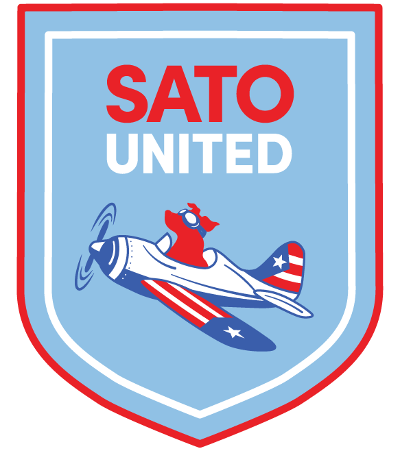 A shield-shaped emblem with a red border, featuring the text 'SATO UNITED' in red and white, and an illustration of a dog pilot in an American flag-themed airplane.