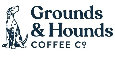 Logo of Grounds & Hounds Coffee Co., featuring a black-and-white illustration of a dog and a smaller dog next to it, with the company's name in bold text.